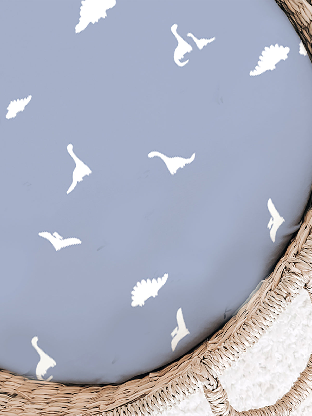 Light blue changing pad cover with white dinosaur silhouettes