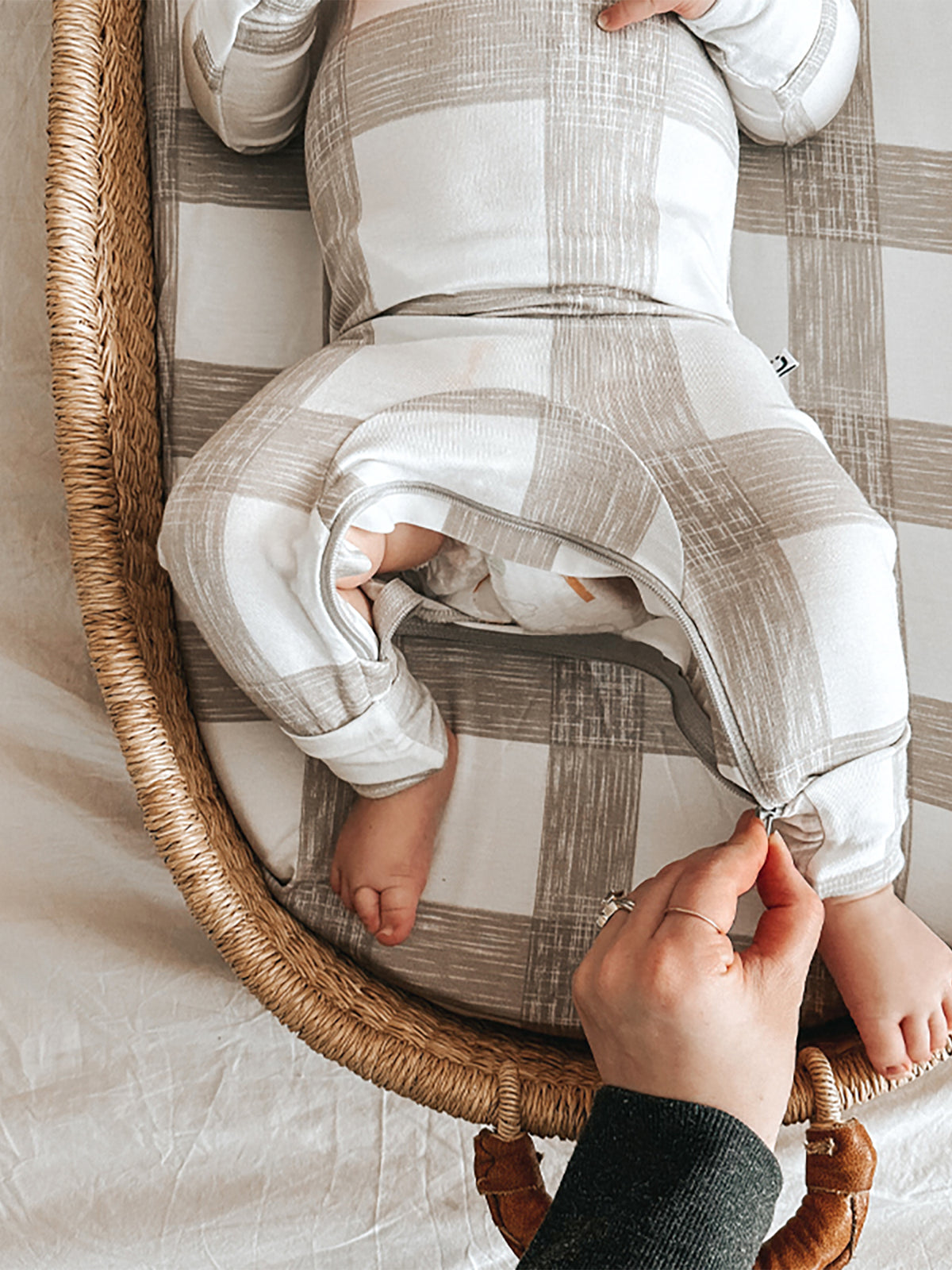 Changing pad cover, light gray and white plaid, with arm-shaped opening