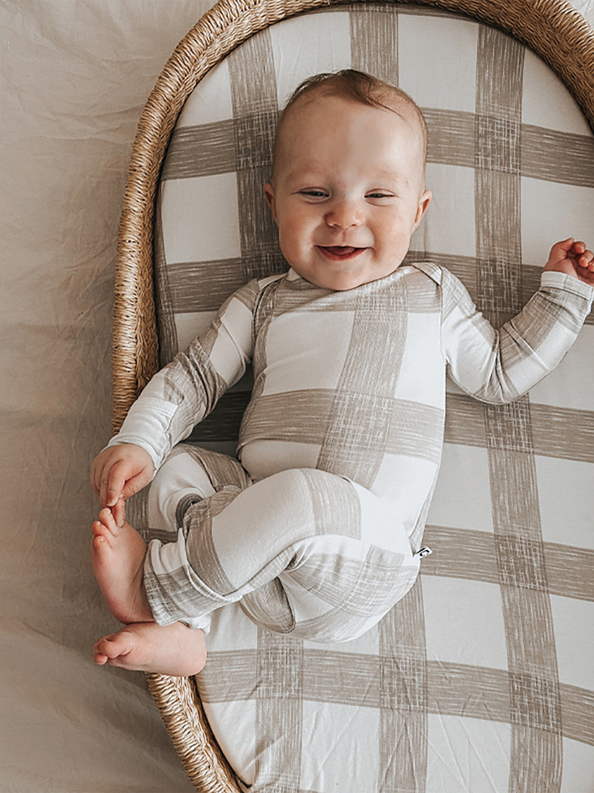 Changing pad cover in light gray and white plaid with full-body wrap
