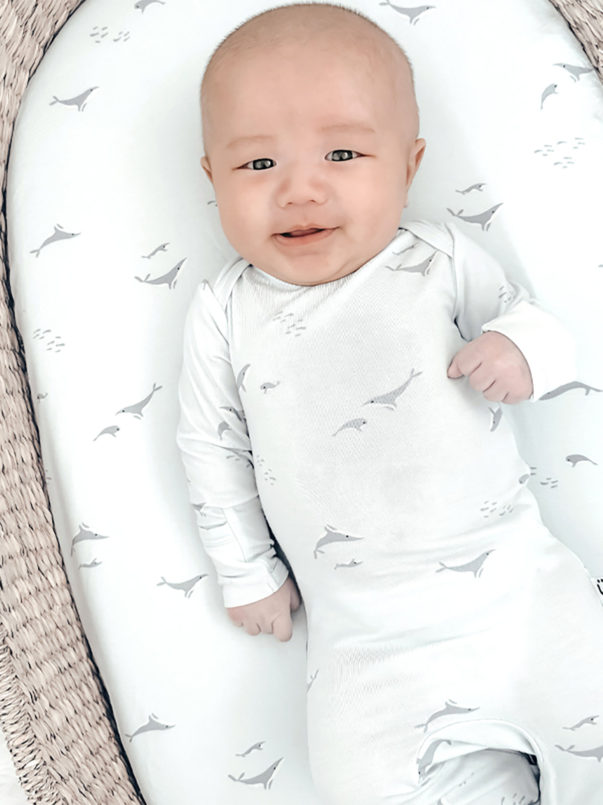 Changing pad cover with light gray whale pattern, soft white fabric