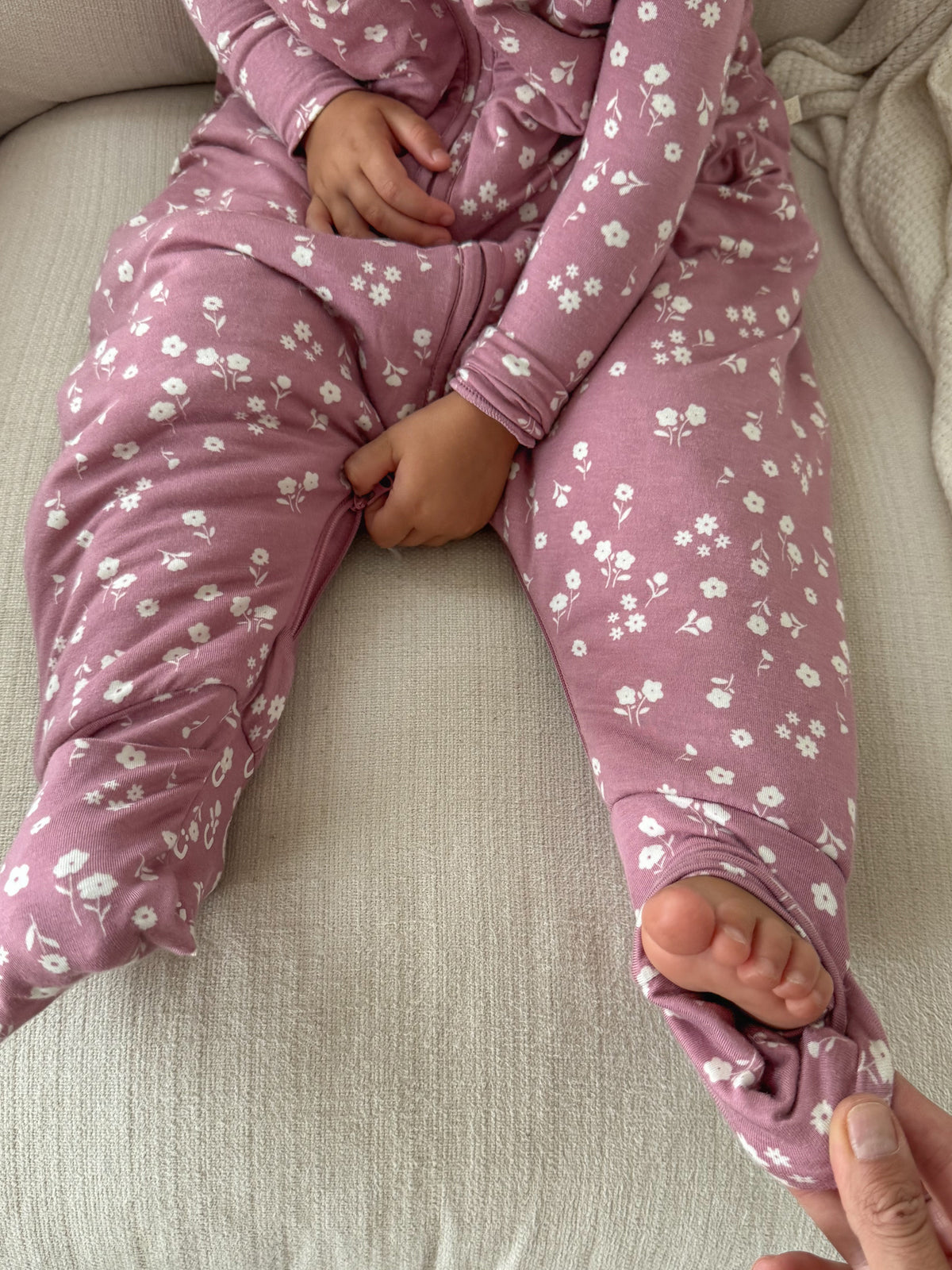Mauve floral footie sleep sack with zipper front, long sleeves and foot openings
