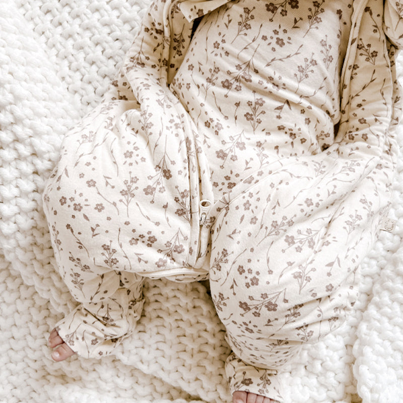 Baby footed sleep sack with cream floral print and front zip opening