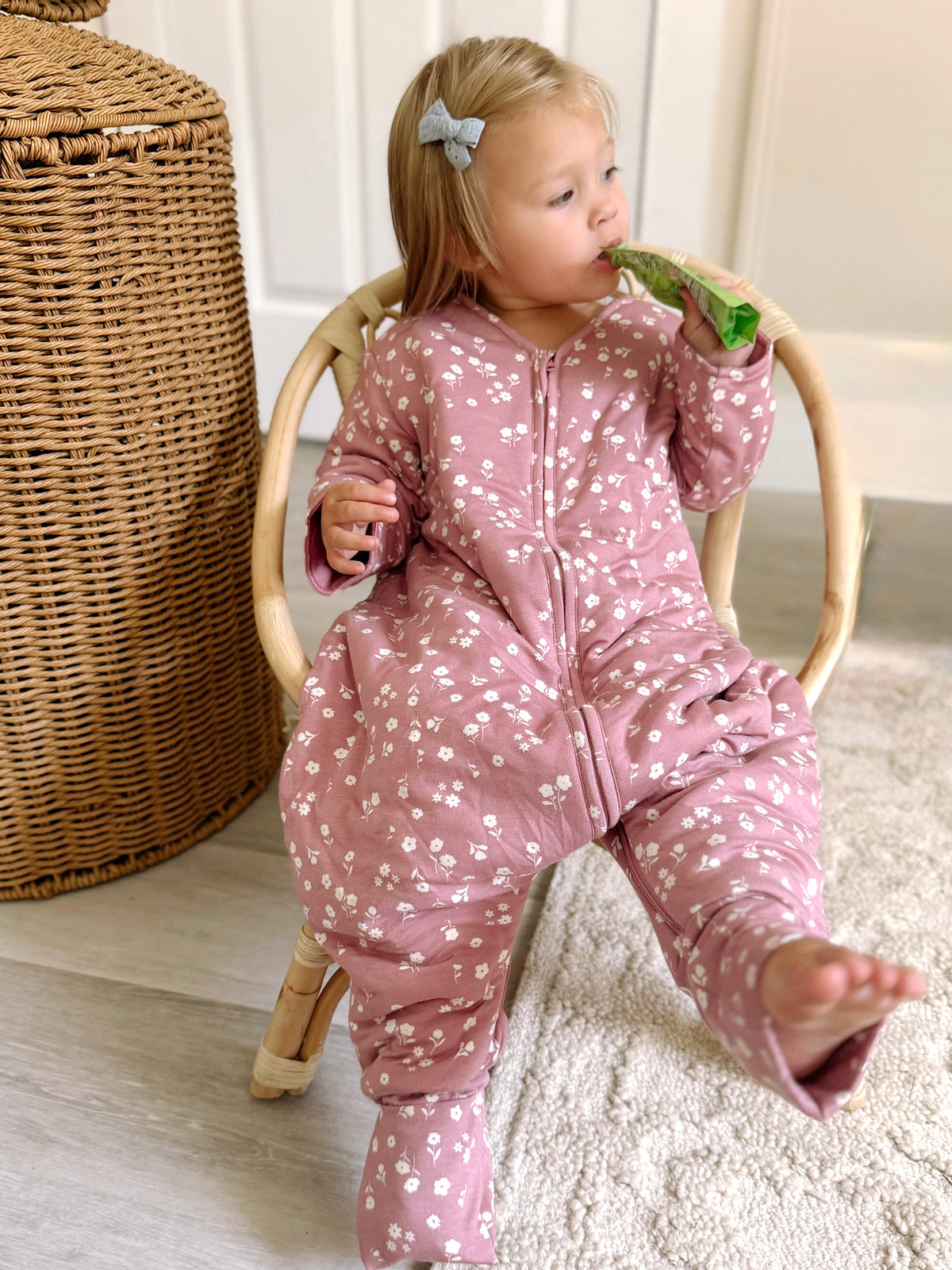 Dusty pink footie sleep sack with mini white floral print, zipper front
