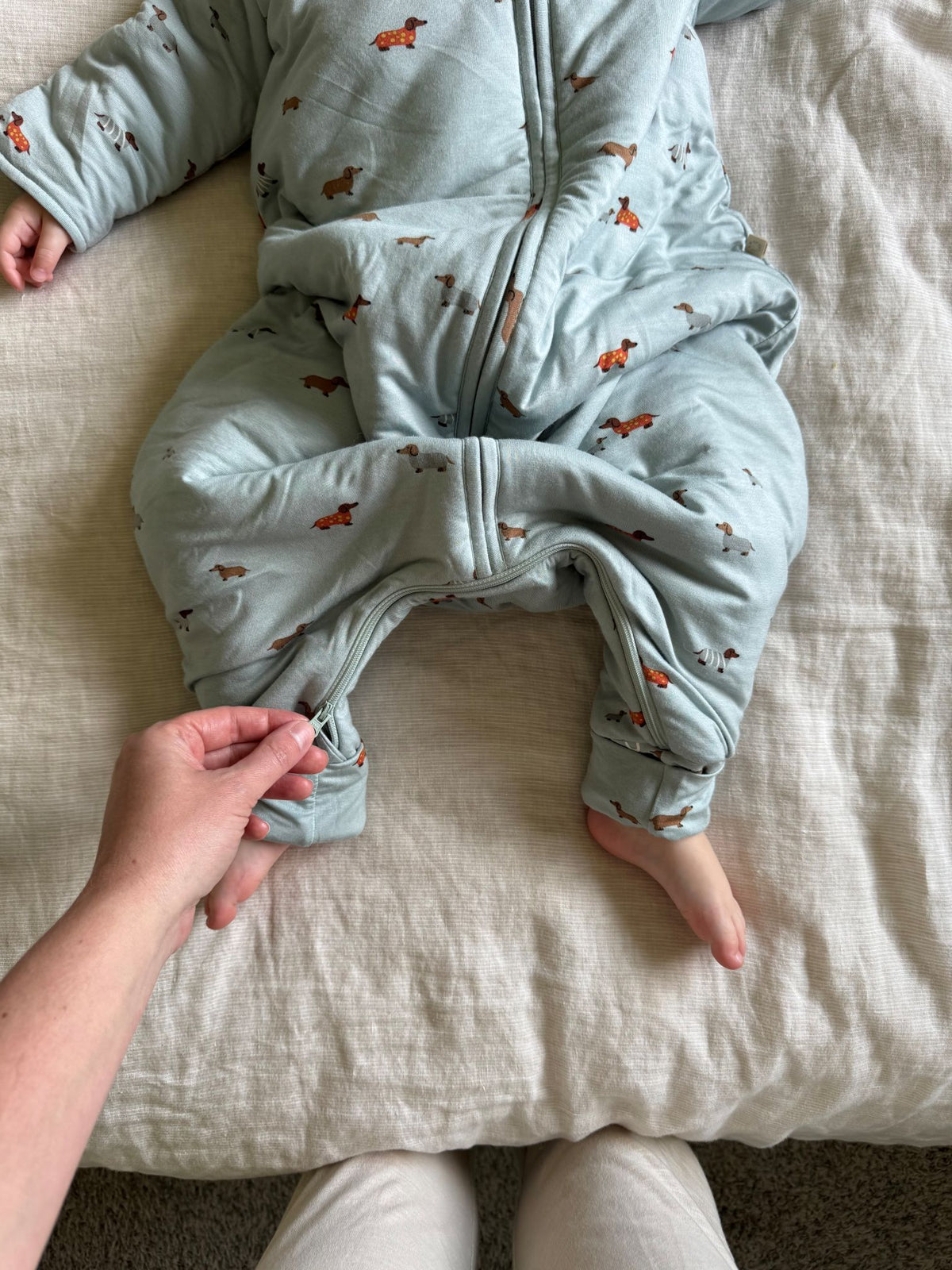 Light blue footed sleep sack with dog print, zip front and fold-over foot opening