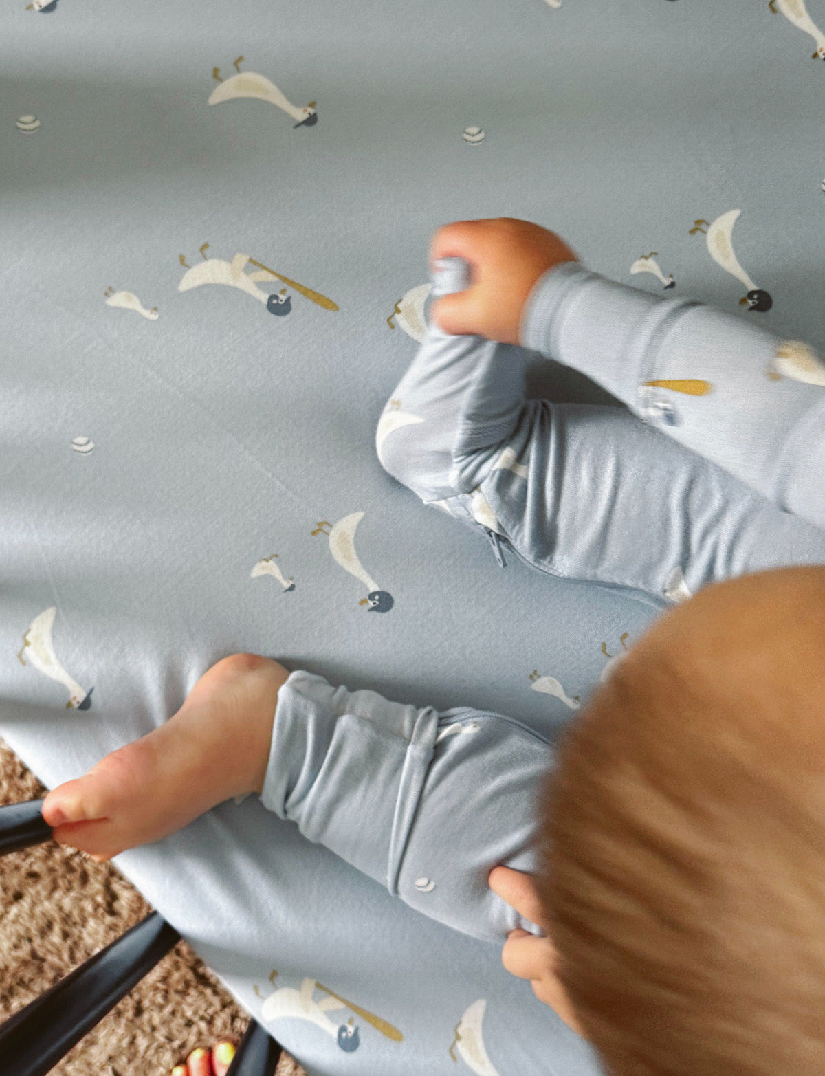 Light blue goose-print convertible baby pajama close-up, long sleeves and covered feet