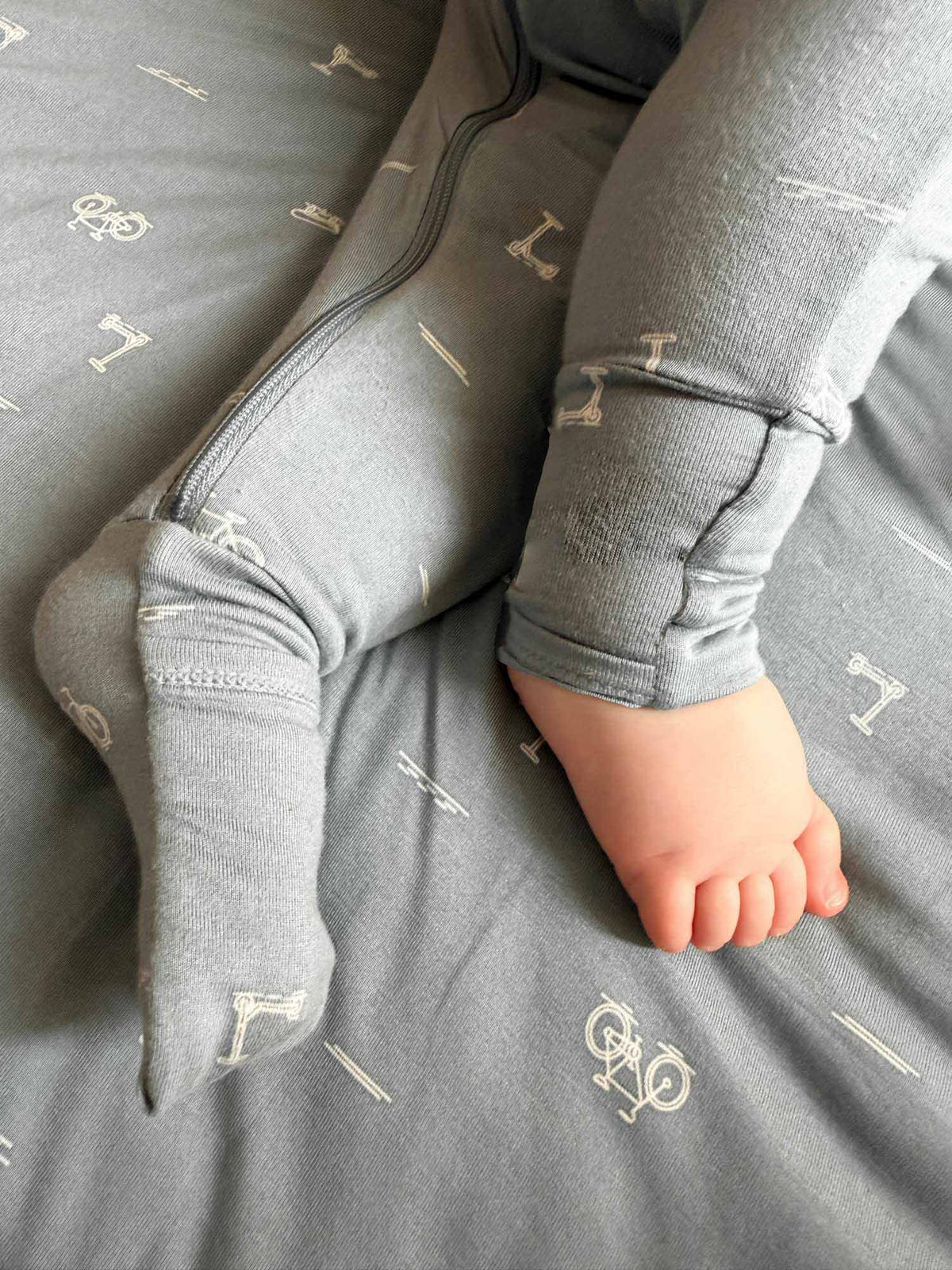 Gray convertible pajama close-up showing foldover hand covers and patterned cuffs