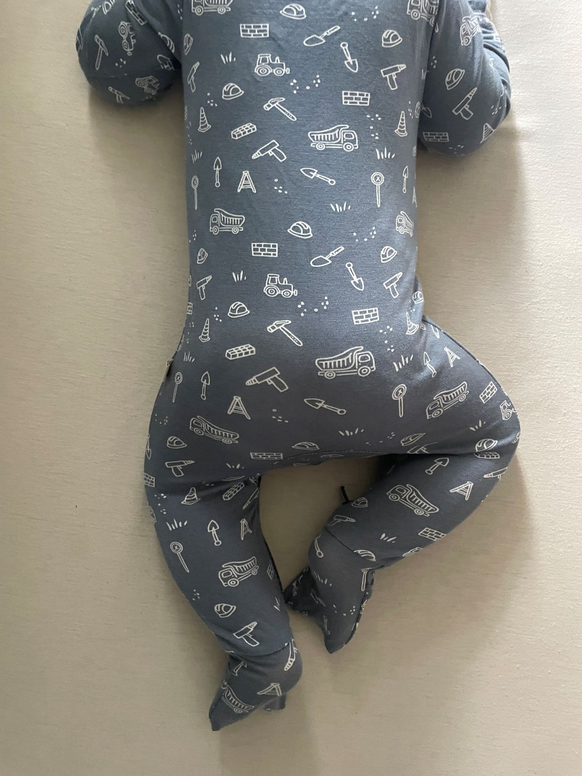 Blue construction-print convertible pajamas with long sleeves and footed legs