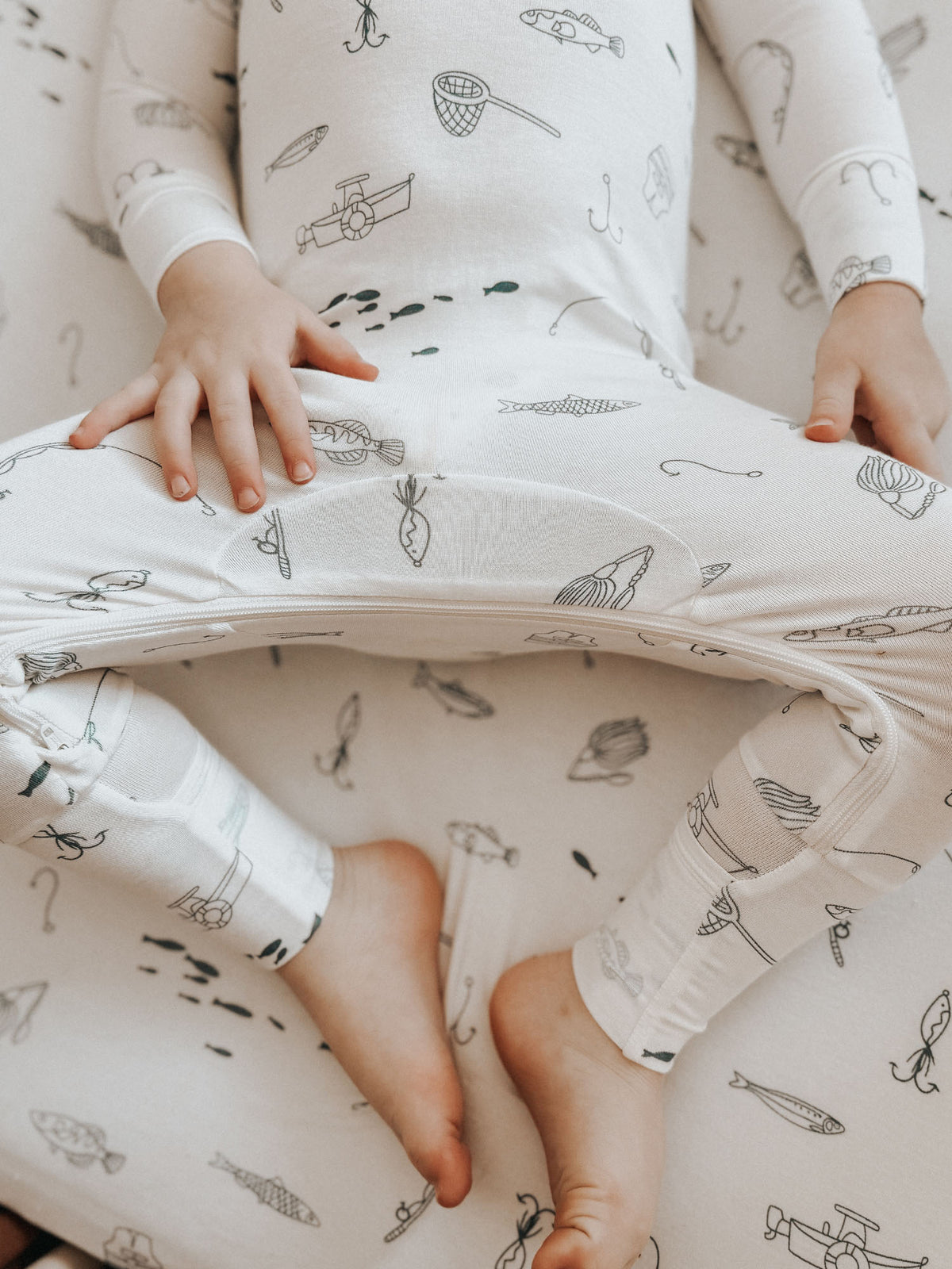 Off-white pajama set with fishing print, leg opening detail and soft fabric close-up