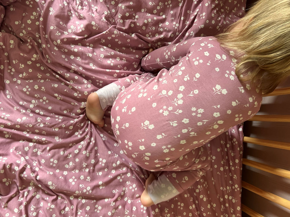 Pink mini floral convertible pajama with long sleeves and footed legs.
