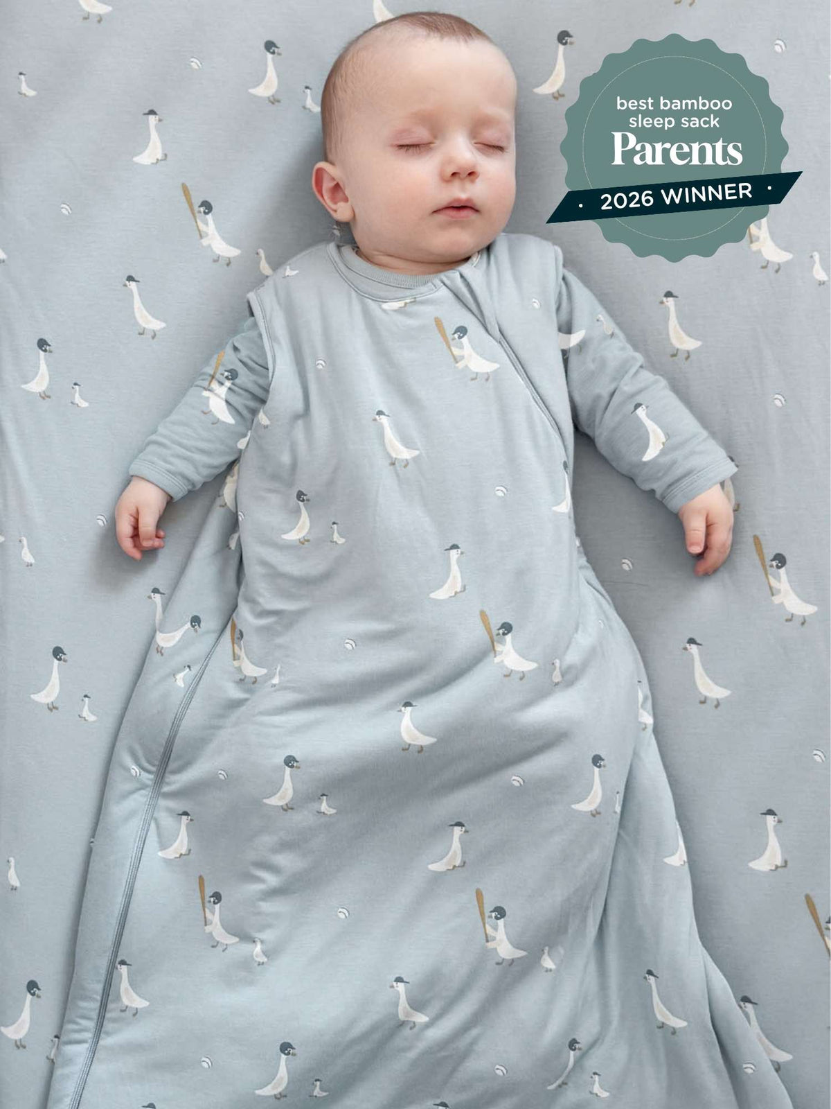 Light blue sleep sack with white goose print, worn by baby