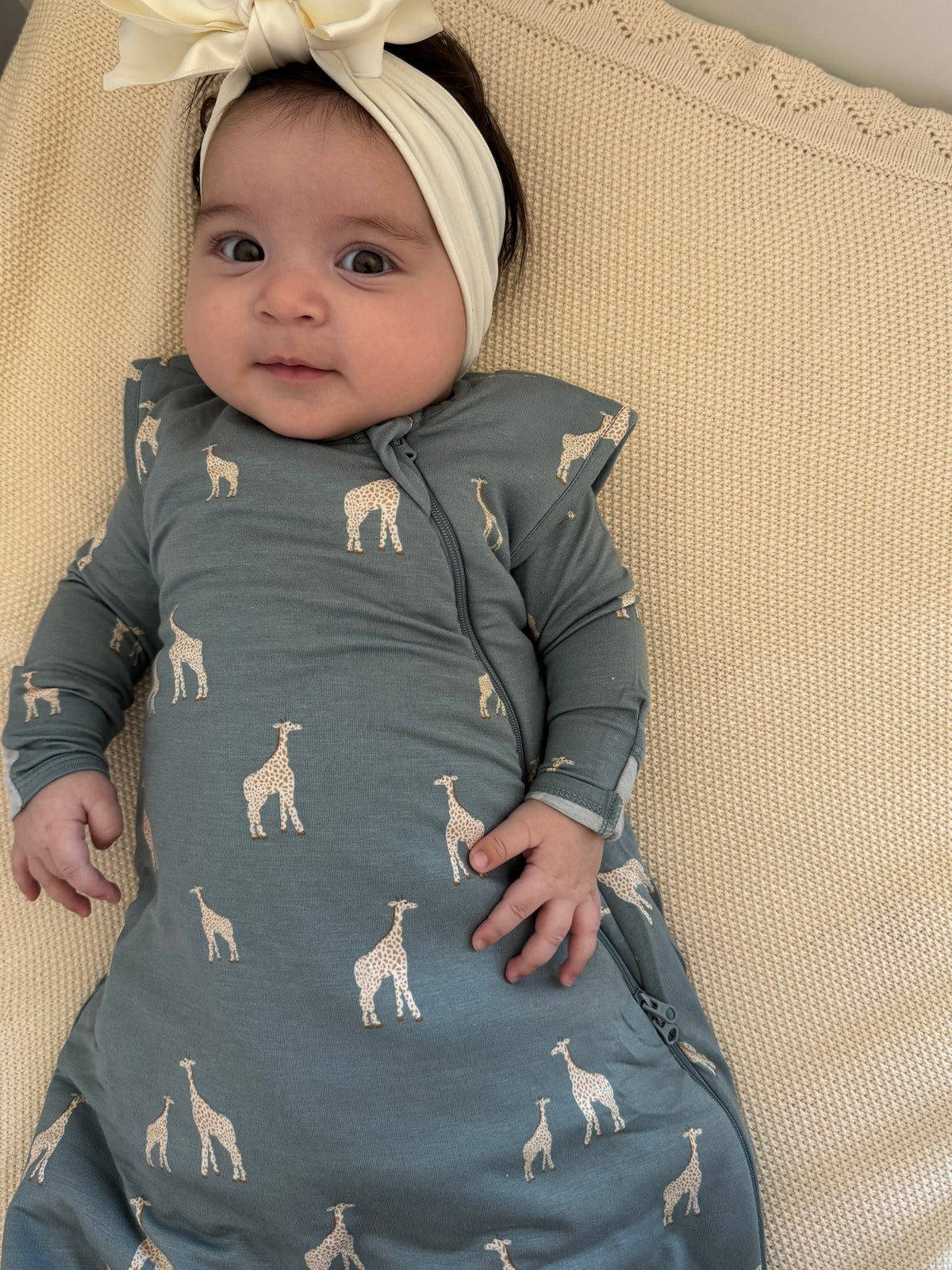 Moss green swaddle sleep sack with giraffe print, zip front and long sleeves