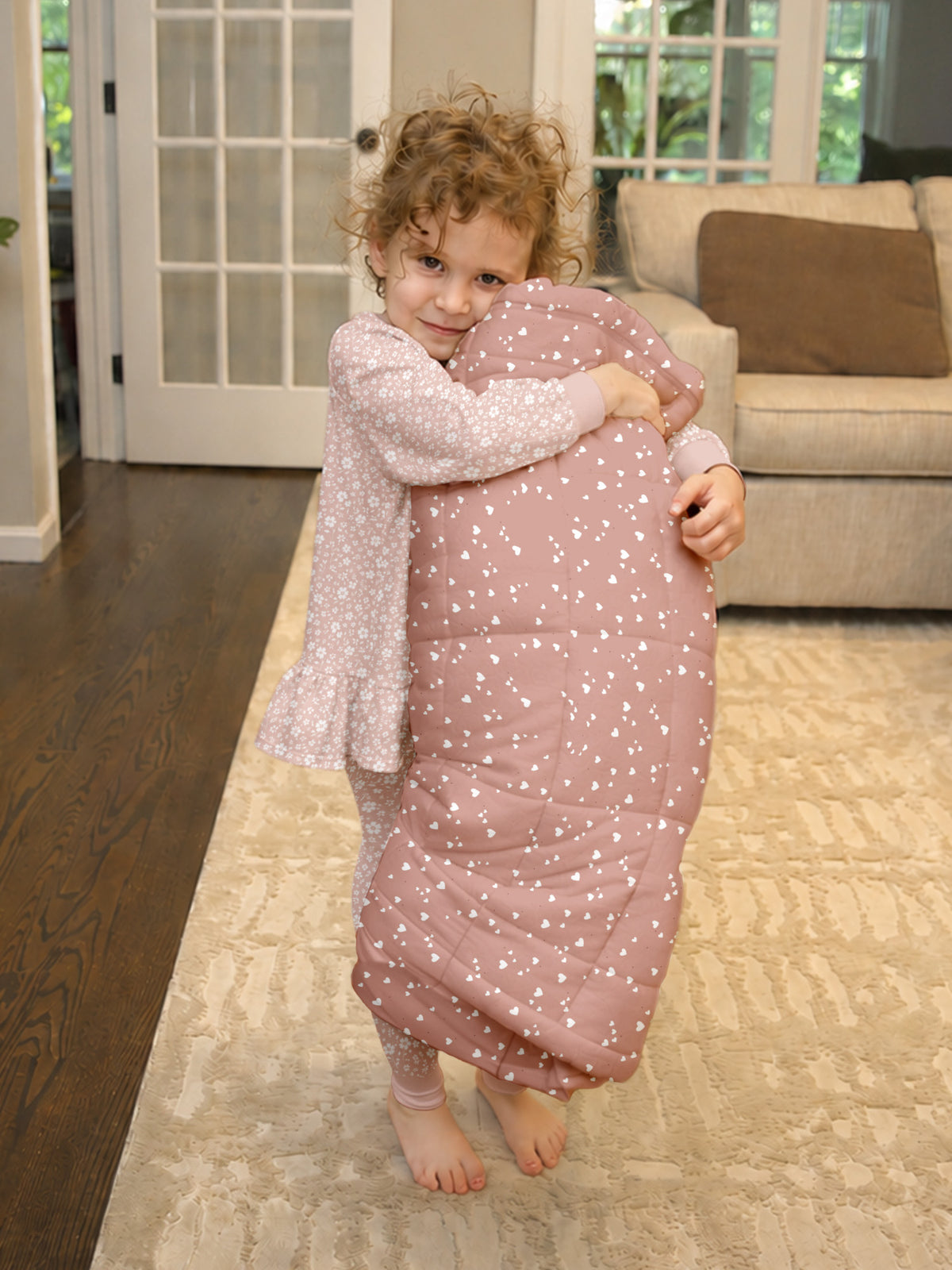 Hearts nap mat worn by toddler, dusty rose with white heart pattern