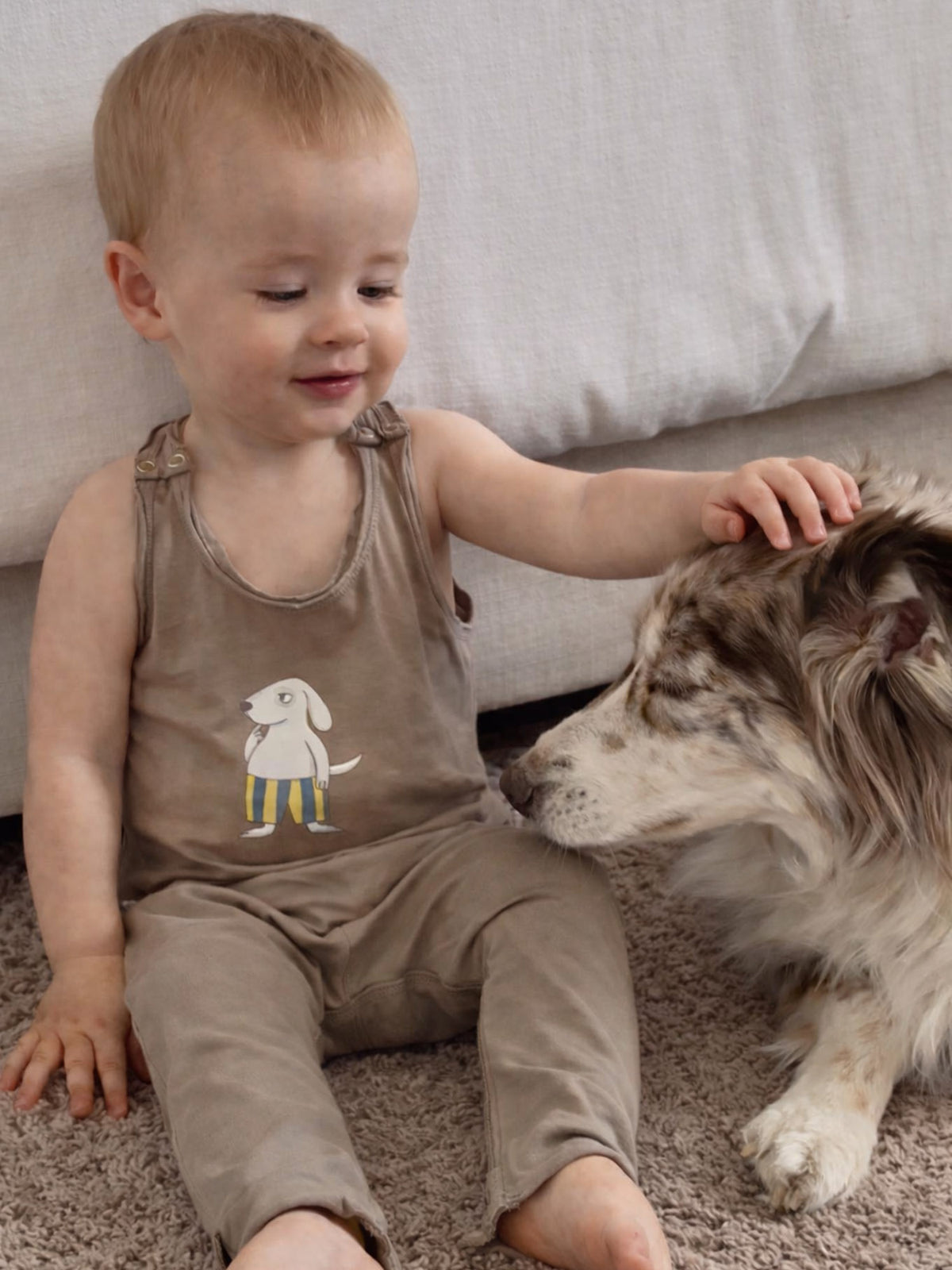 Kids' taupe sleeveless romper with dog graphic, full-length legs