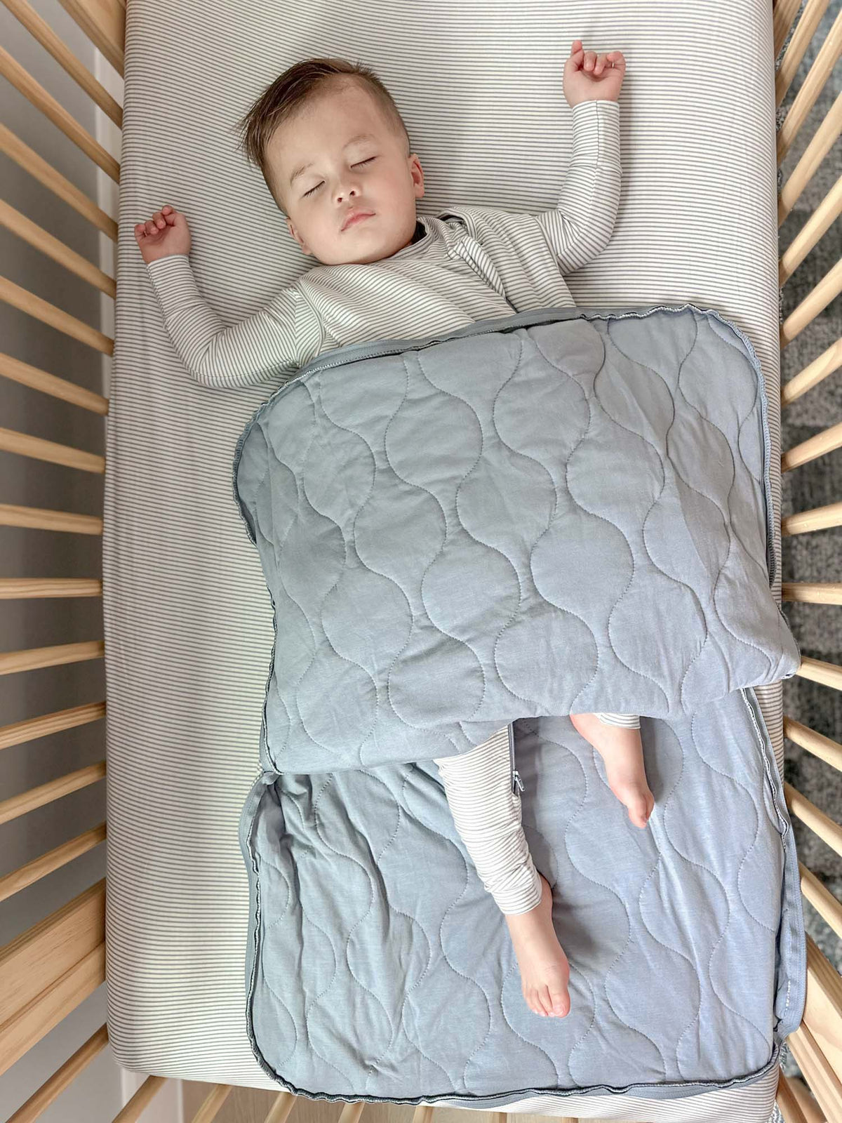 Blue striped sleep sack with zipper front and quilted circular panel design