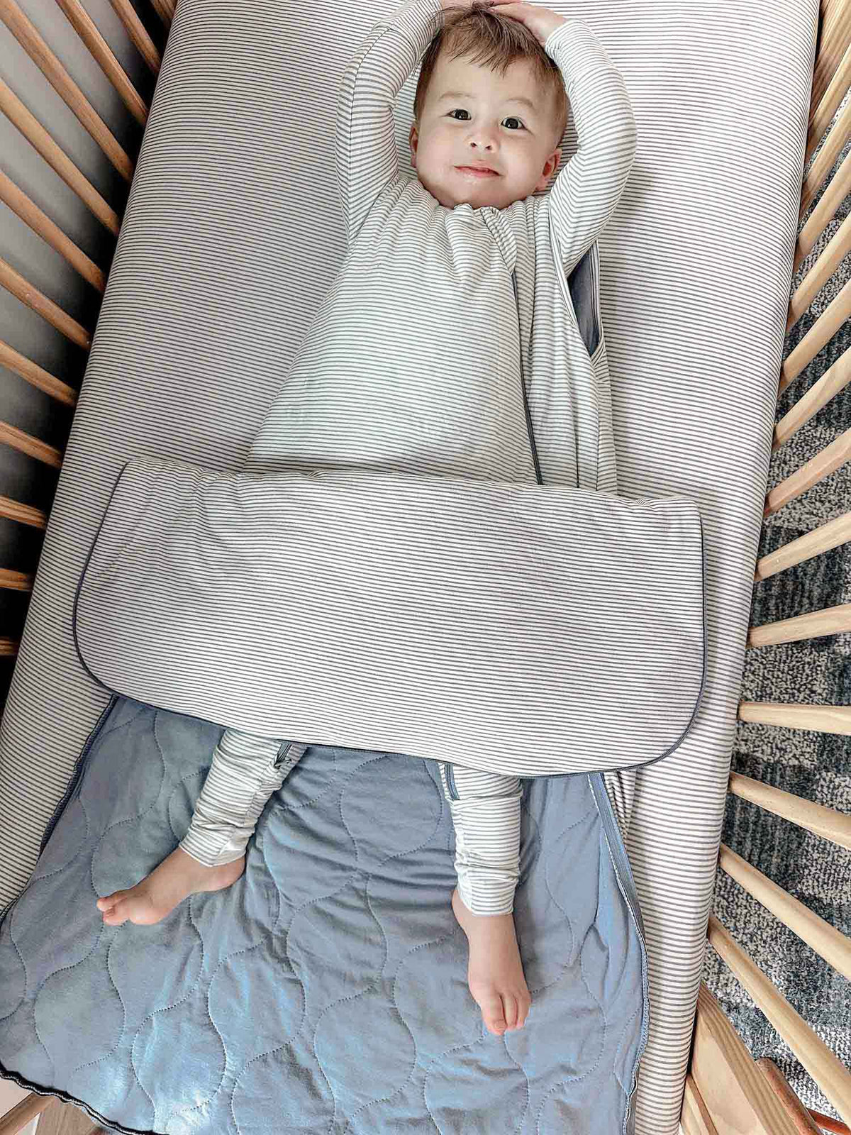 Blue striped sleep sack with zipper front and padded quilted body panels