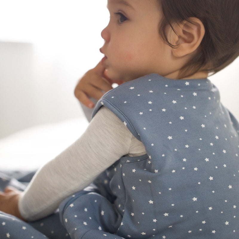 Blue sleep sack with white stars and long gray sleeves, close-up