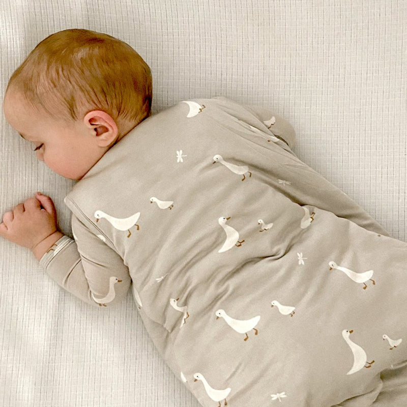 1.0 TOG baby sleep sack in light gray with white duck print, snap shoulder closures