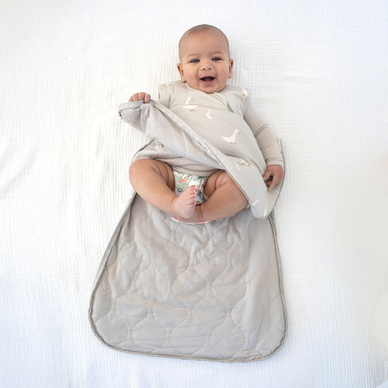 Light gray baby sleep sack with white duck print, full-wrap wearable blanket design