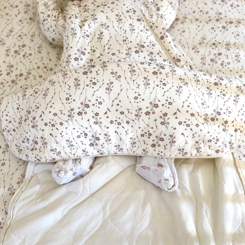 Floral long-sleeve sleep sack with front zipper and covered legs, cream base