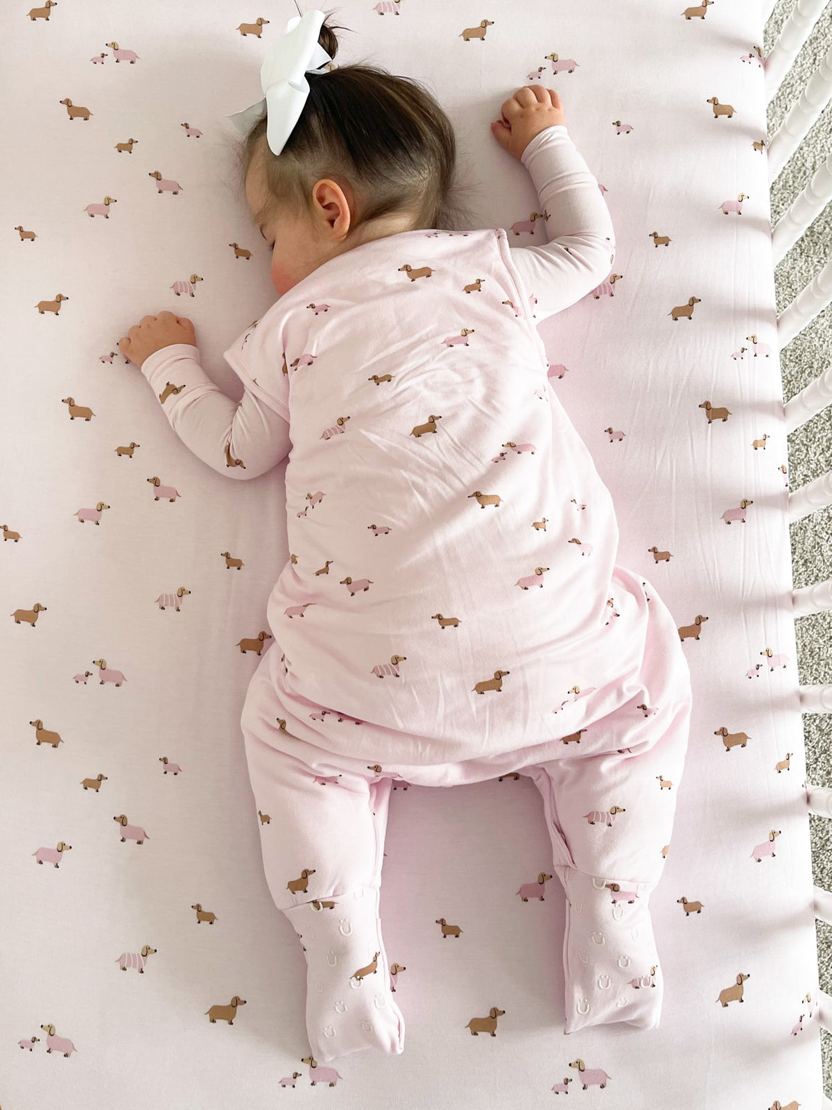 Dog-print footie sleep sack with zipper, covered feet, and fold-over hand cuffs