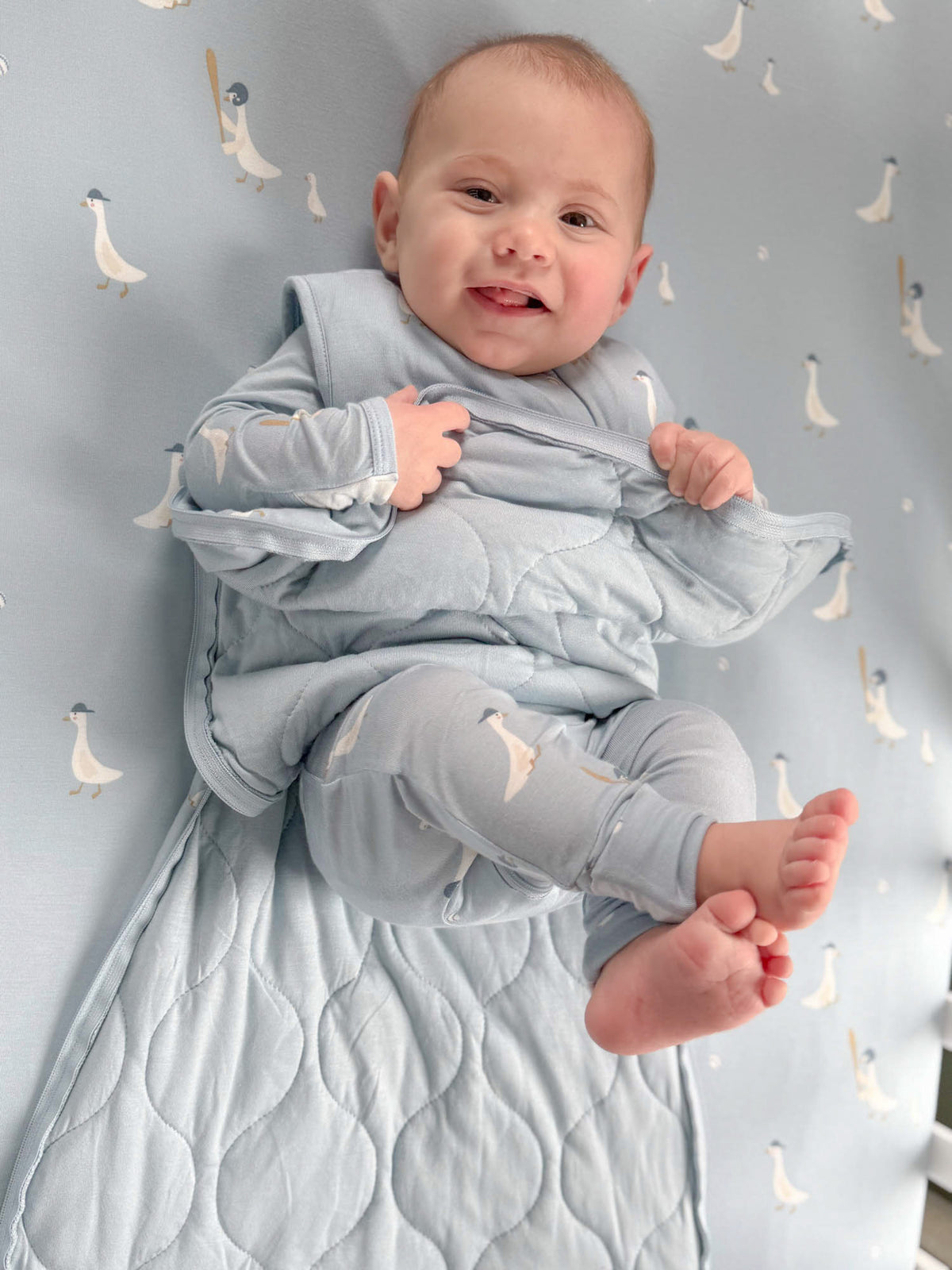 Light blue goose-print sleep sack with zip front and arm openings, 1.0 TOG