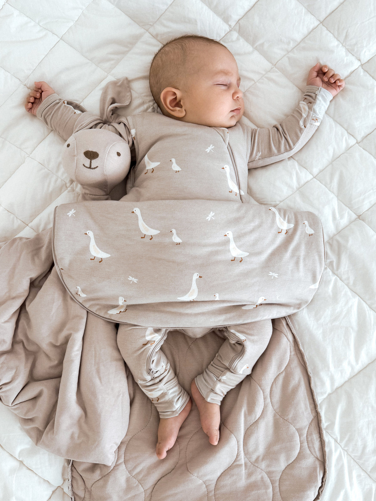 Transitional swaddle sleep sack, beige with white goose print, foldover swaddle panel