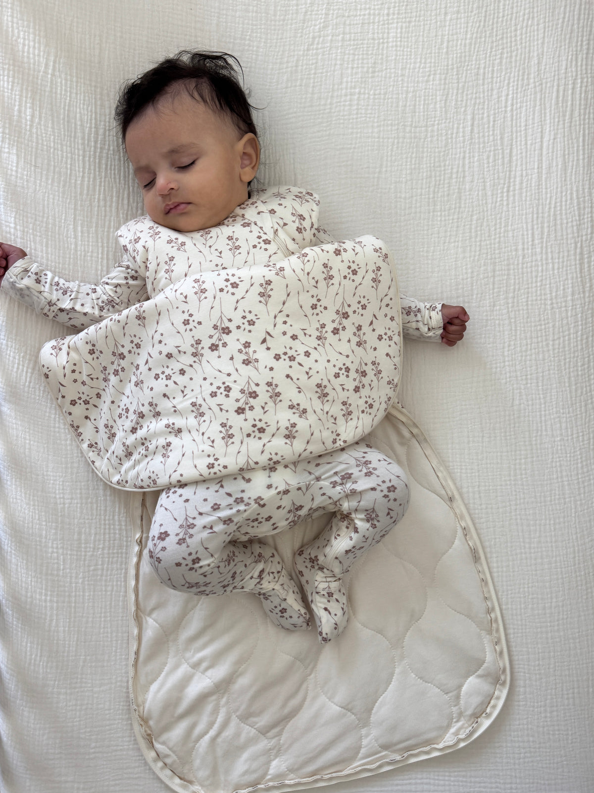 2.5 TOG transitional swaddle sleep sack, floral print, baby wrapped with arms out