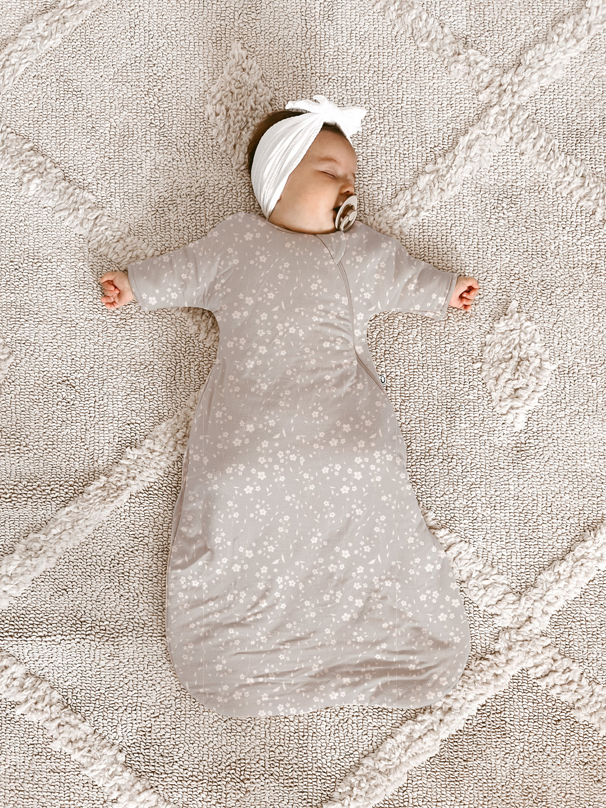 Long sleeve swaddle sack in beige with white floral print, long sleeves and zipper