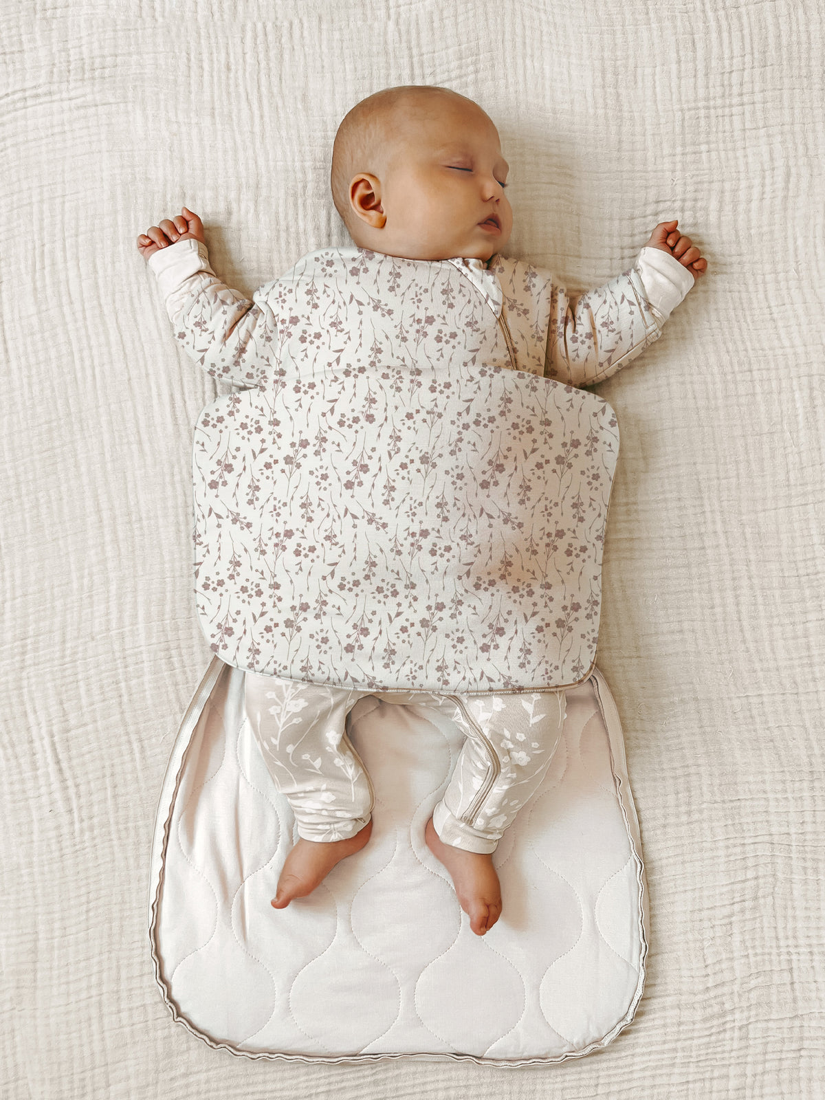 Cream 1.0 TOG swaddle sack, long sleeves with small floral print, open leg bottom