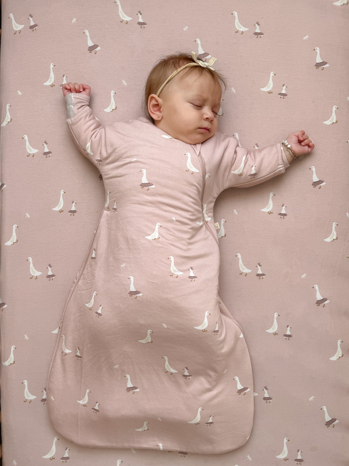 Long sleeve swaddle sack, dusty pink with allover white goose pattern