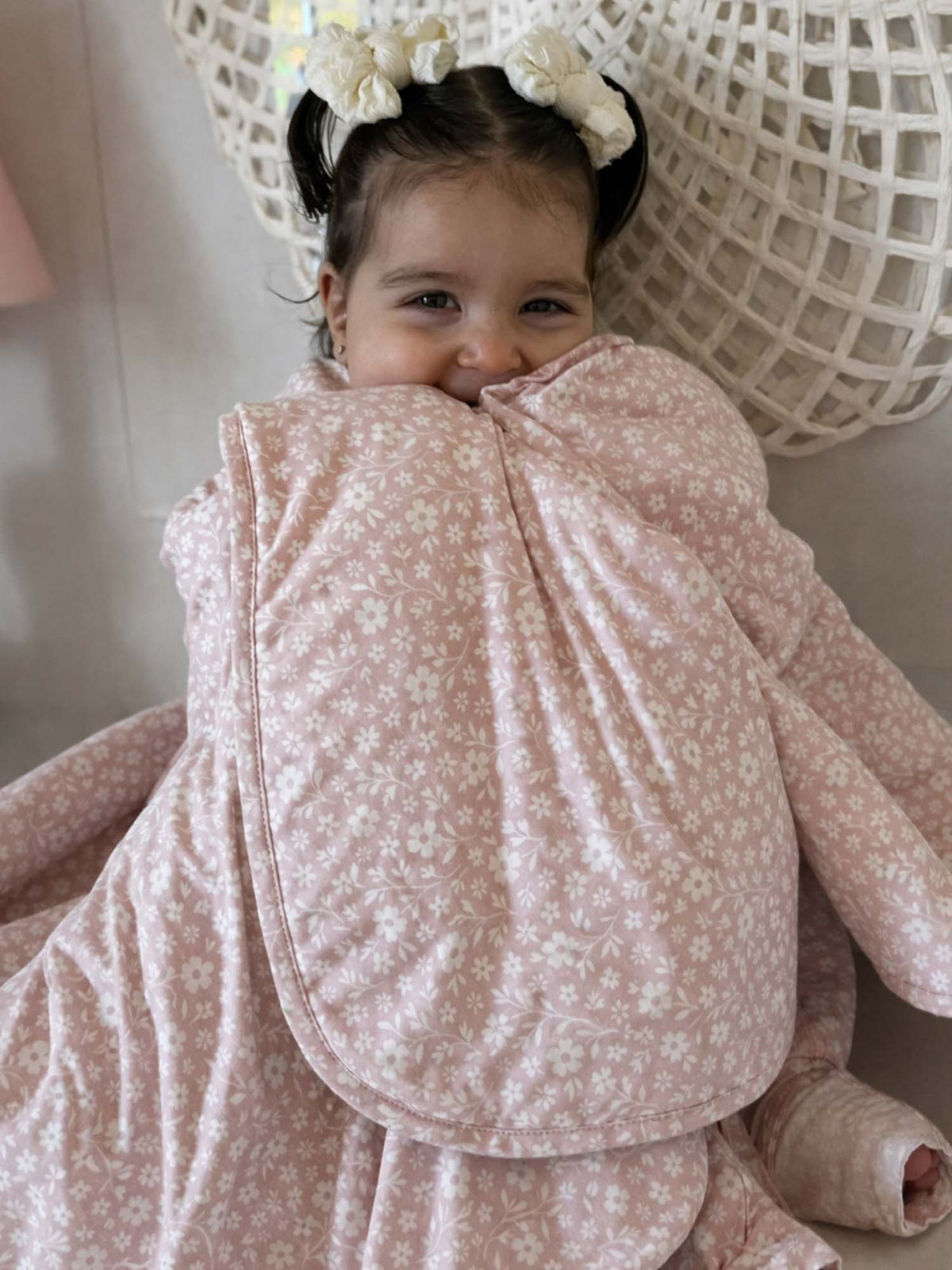 Pink floral baby blanket wrap with rounded front and satin-trim edging