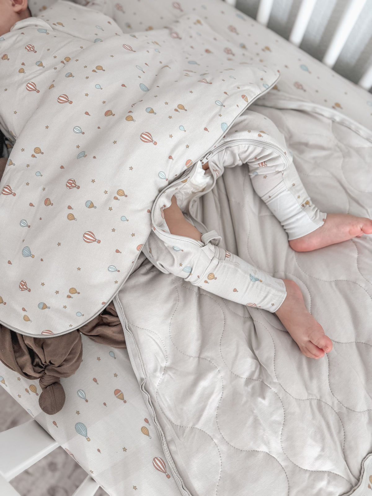 1.0 TOG sleep sack in cream with multicolor planet print, front zipper and cuffed sleeves
