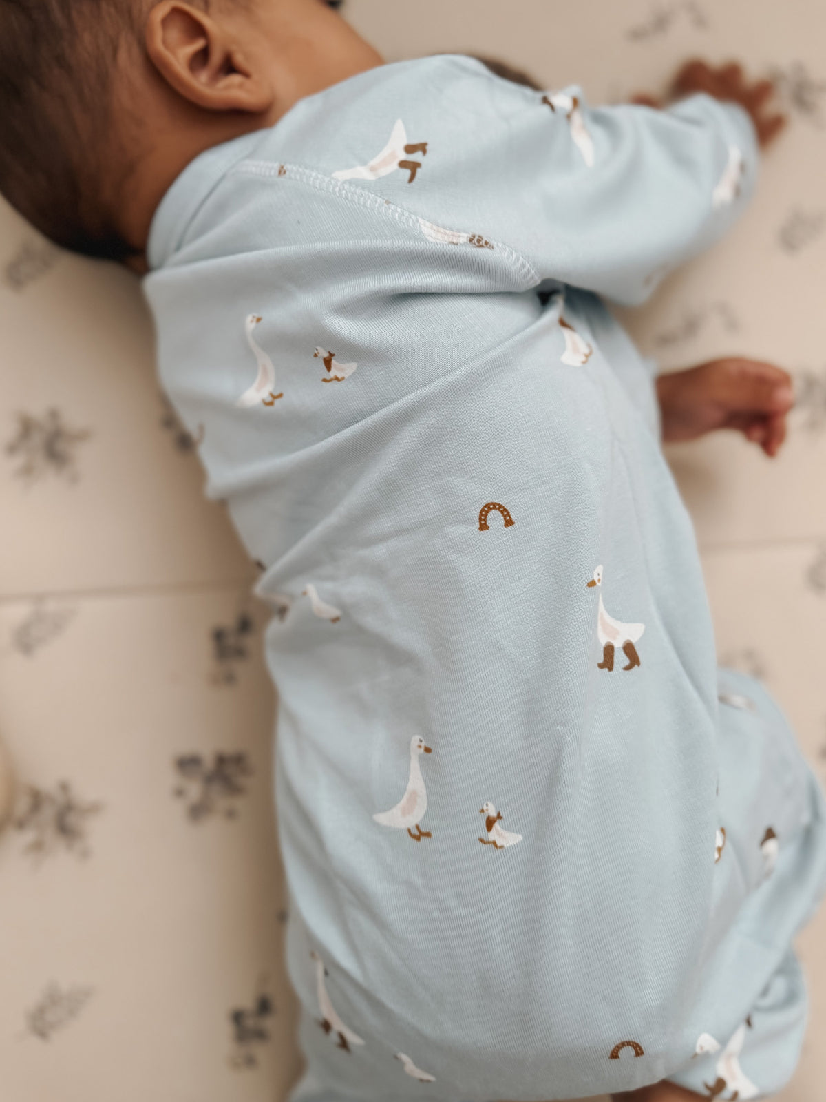 Light blue fleece jumpsuit with animal print, back view with full leg coverage