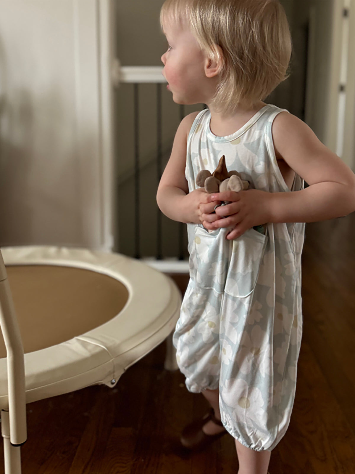 Sleeveless white floral romper with elastic legs and crew neckline