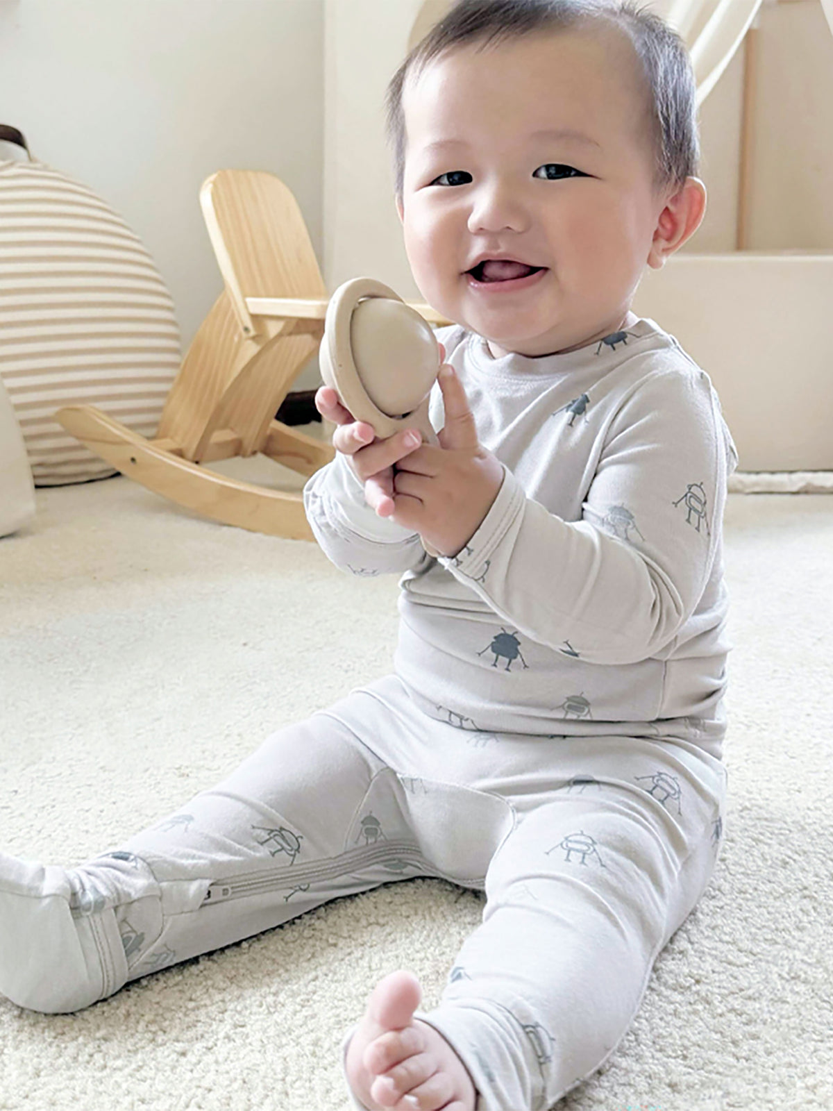 Light gray baby footie set with small robot print, long sleeves and footed legs