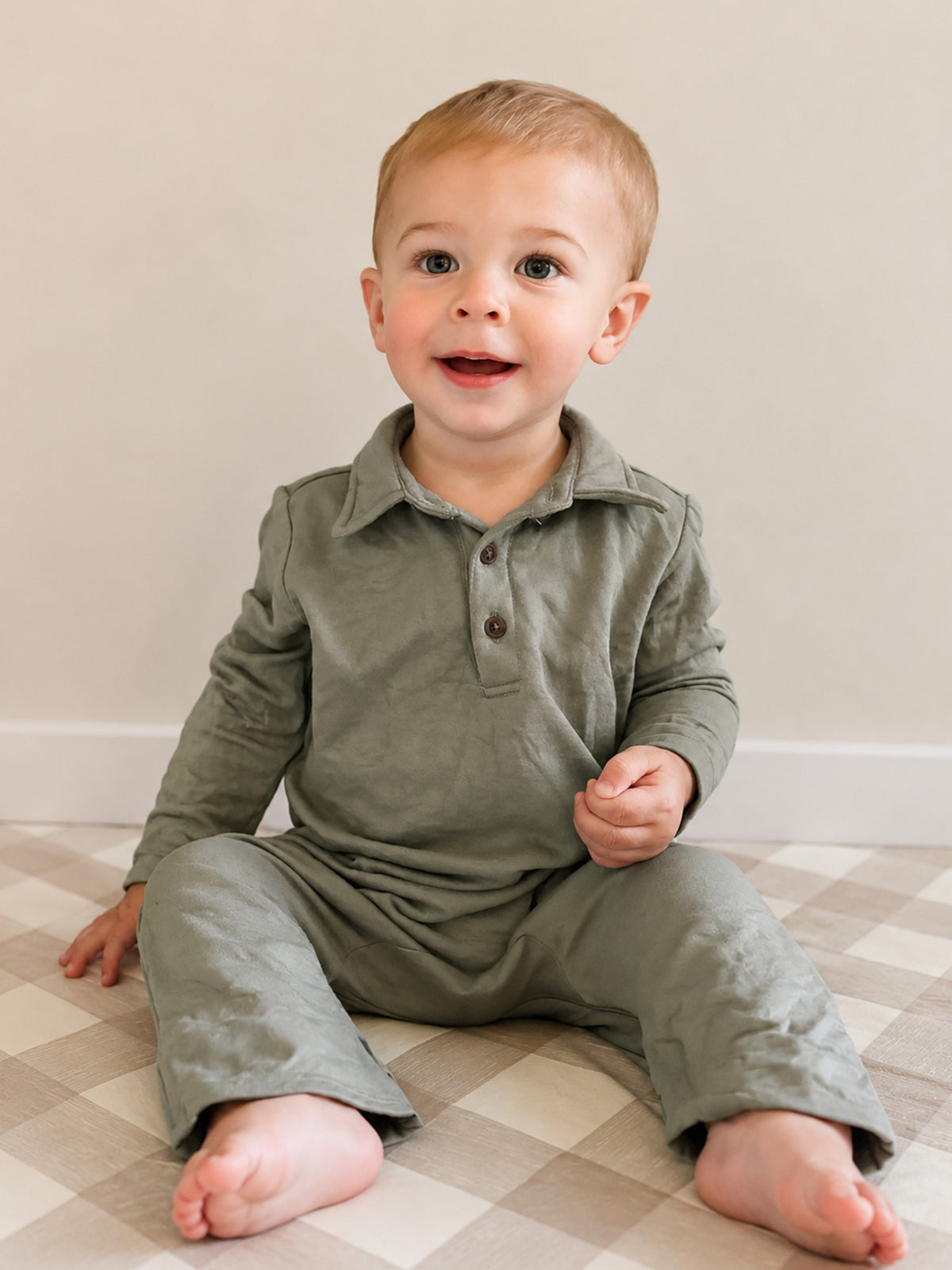 Sage green fleece collared baby jumpsuit, button front and roomy long legs
