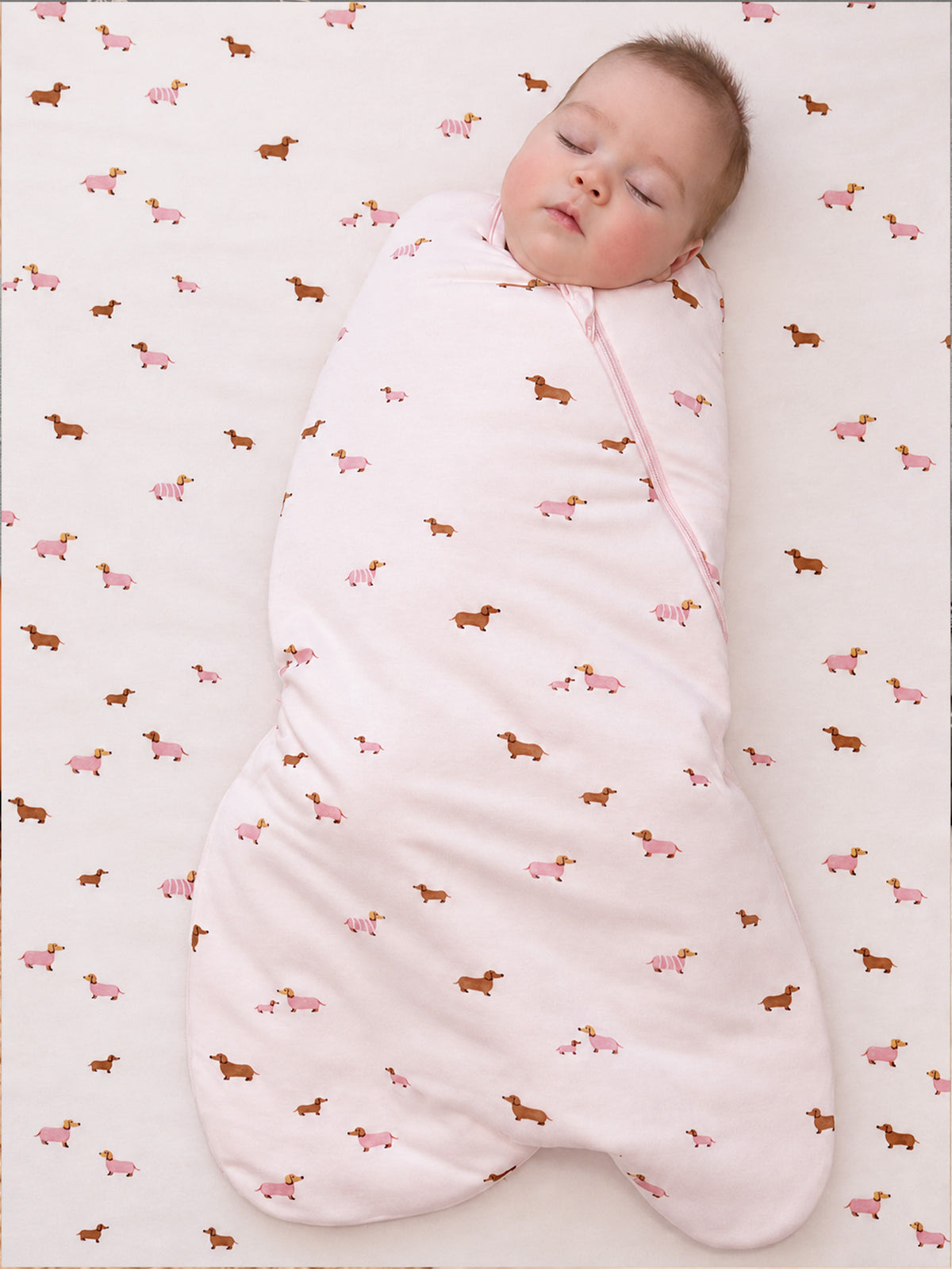 Quilted swaddle sleep sack with dachshund and pink dog print, full-length pink zipper