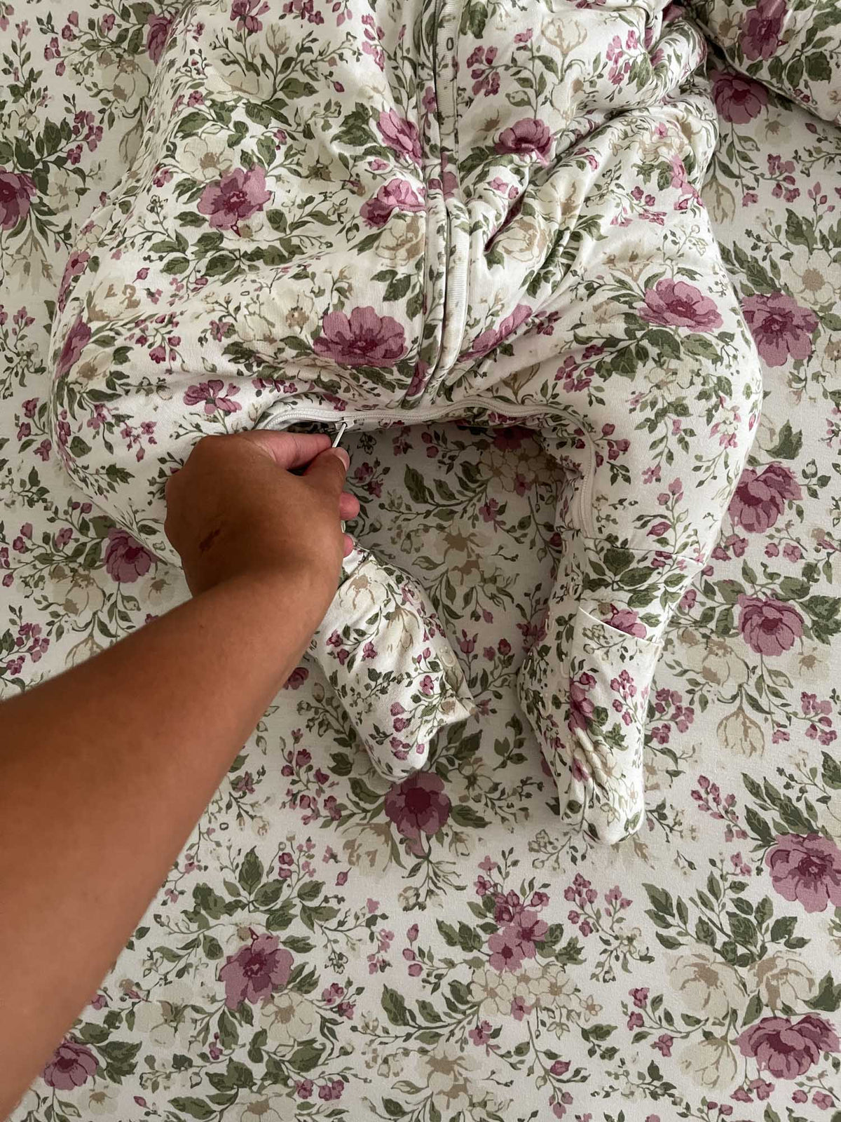 Floral long-sleeve sleep sack with footed legs and visible front zipper, rose print