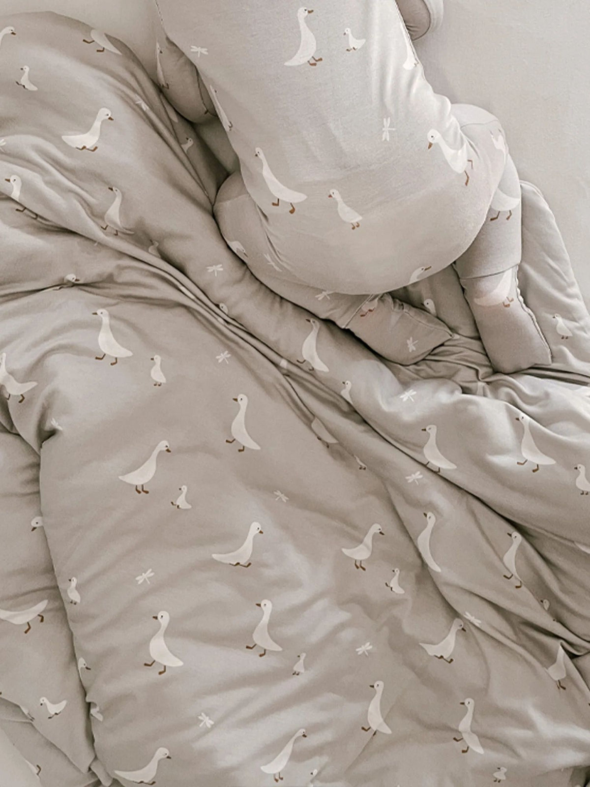 Goose-print cloud blanket, light cream close-up with repeating small white geese