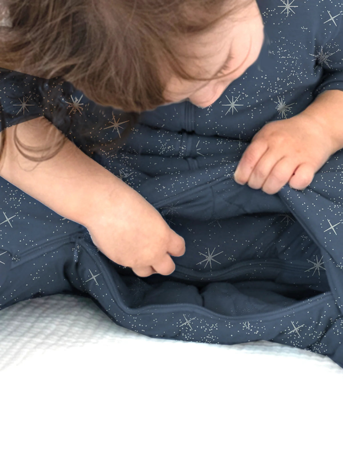 Dark blue star-print footie sleep sack with long sleeves, gathered fabric detail