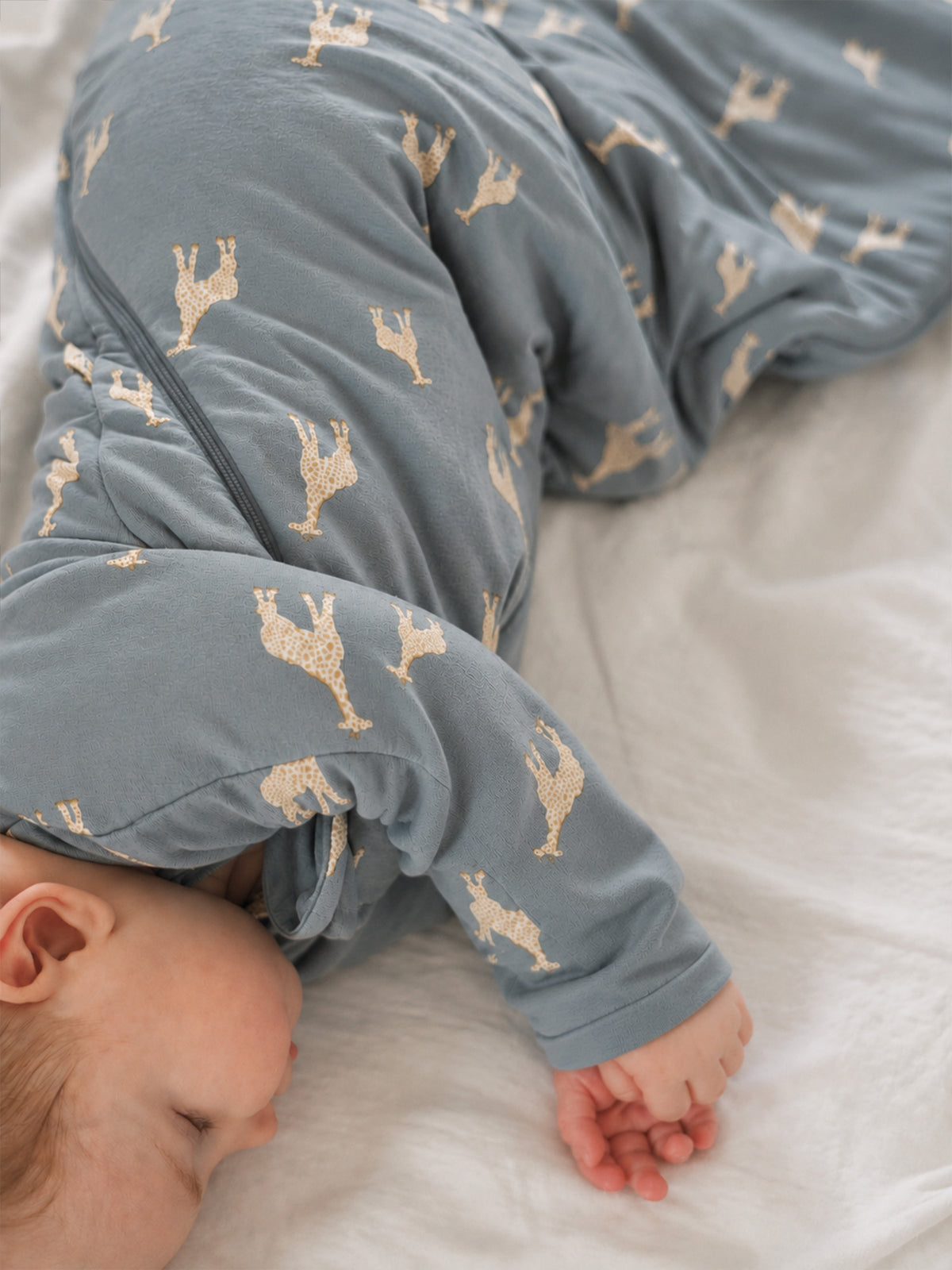 Baby swaddle sleep sack with beige giraffe pattern, long sleeves