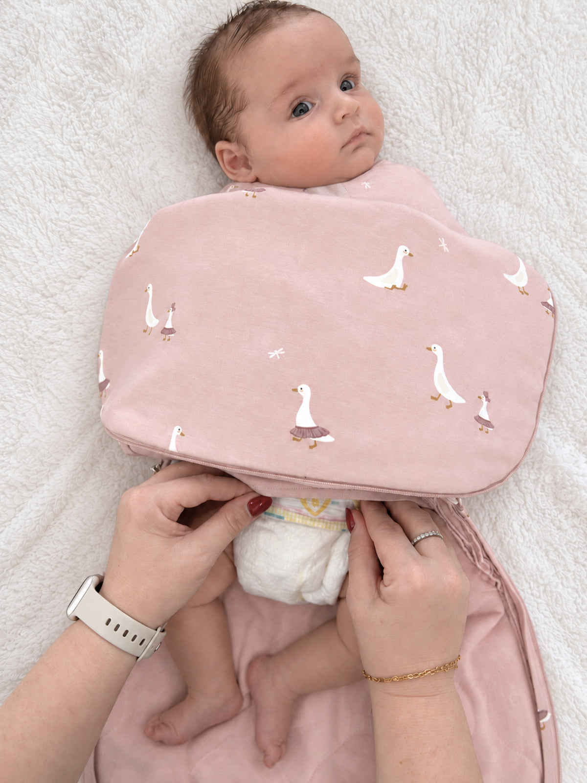 Pink goose-print swaddle sleep sack with folded wrap front and zipper