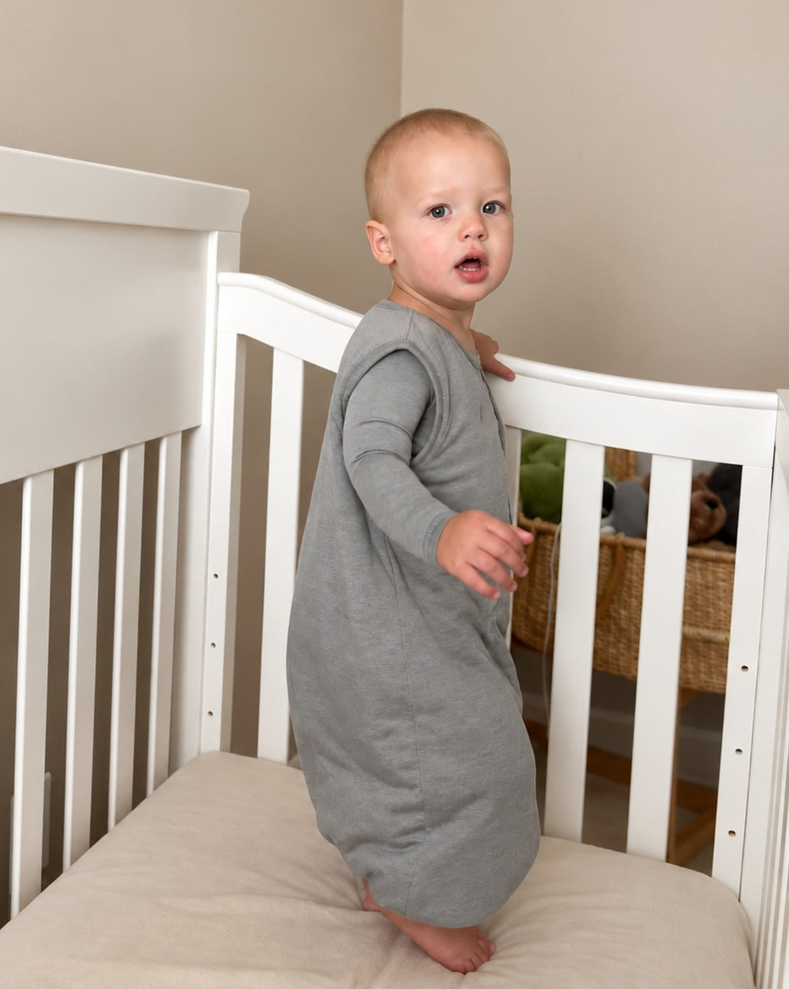 Sage green footie sleep sack with front zipper, long sleeves, and footed legs