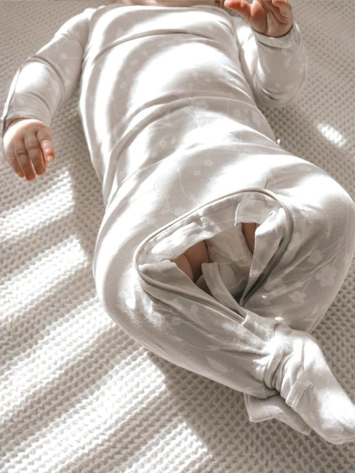 Light convertible footed pajama with white floral print and fold-over sleeve cuffs