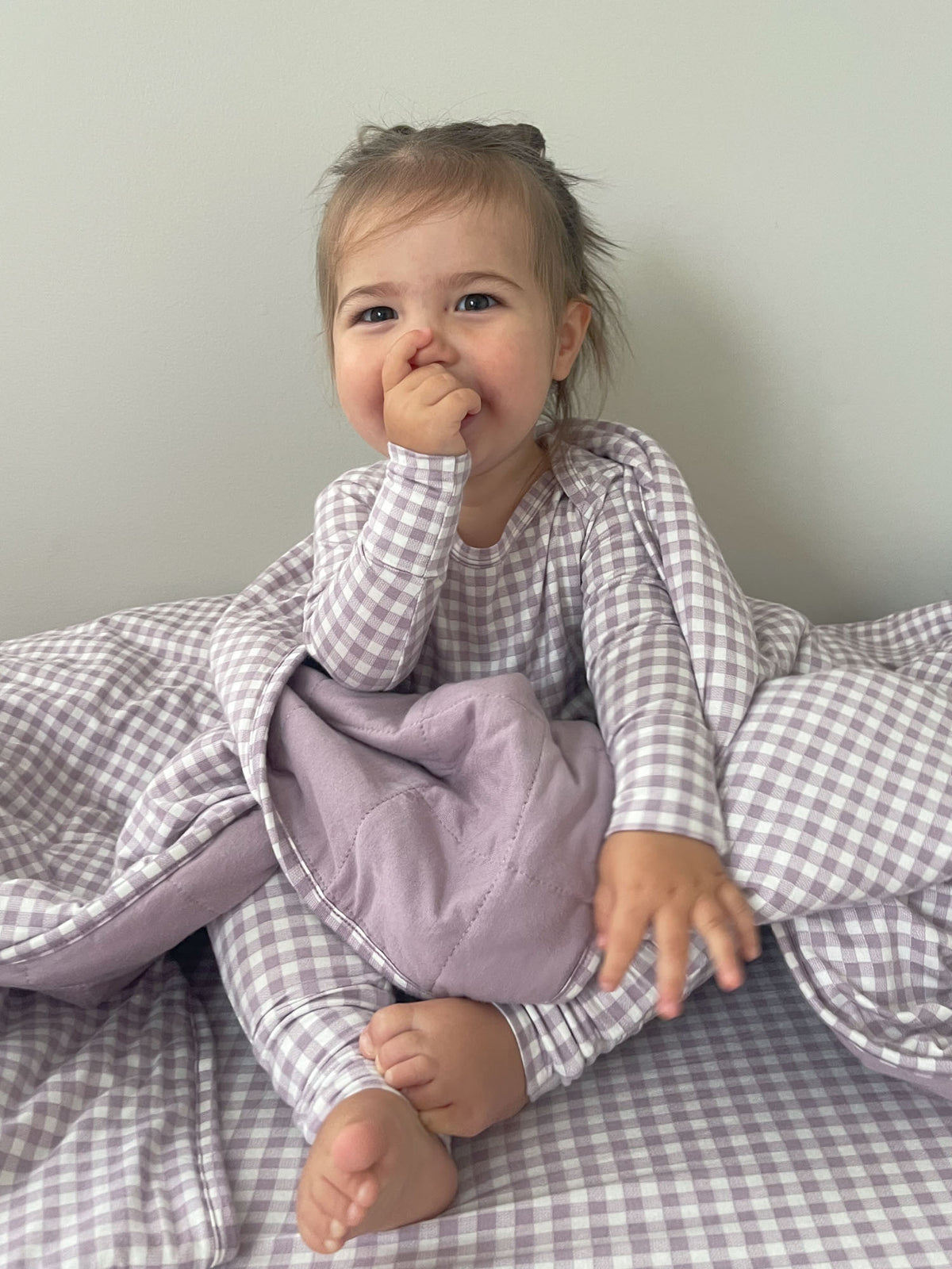 Toddler in hooded cloud blanket, purple-and-white gingham with lavender front lining