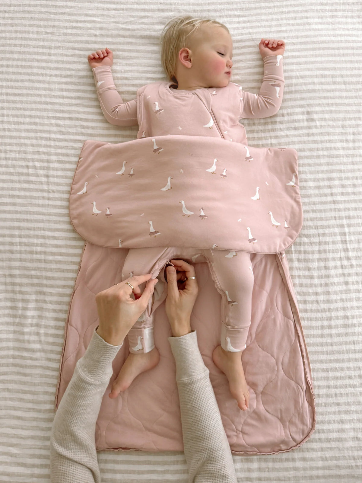 Pink 1.0 TOG sleep sack with goose print, open bottom with legs out