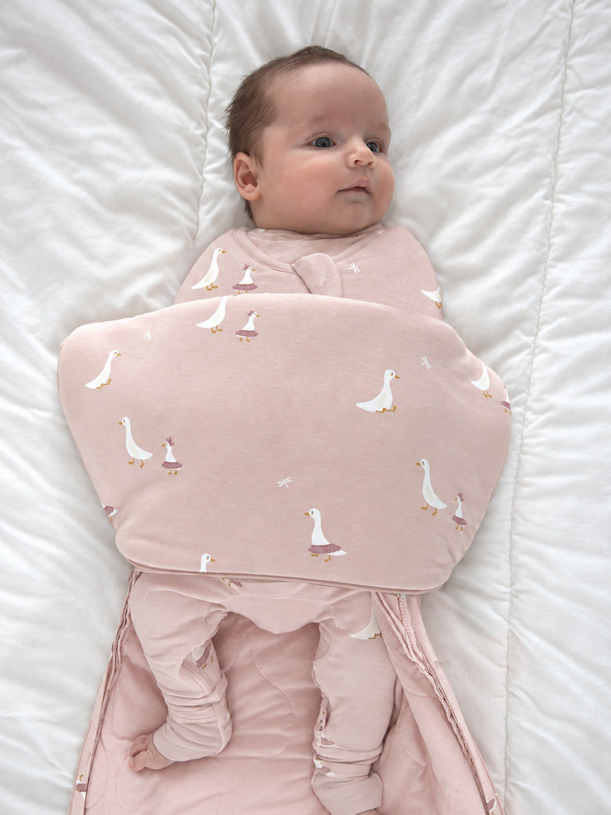 Pink goose-print swaddle sleep sack with folded front for secure swaddling