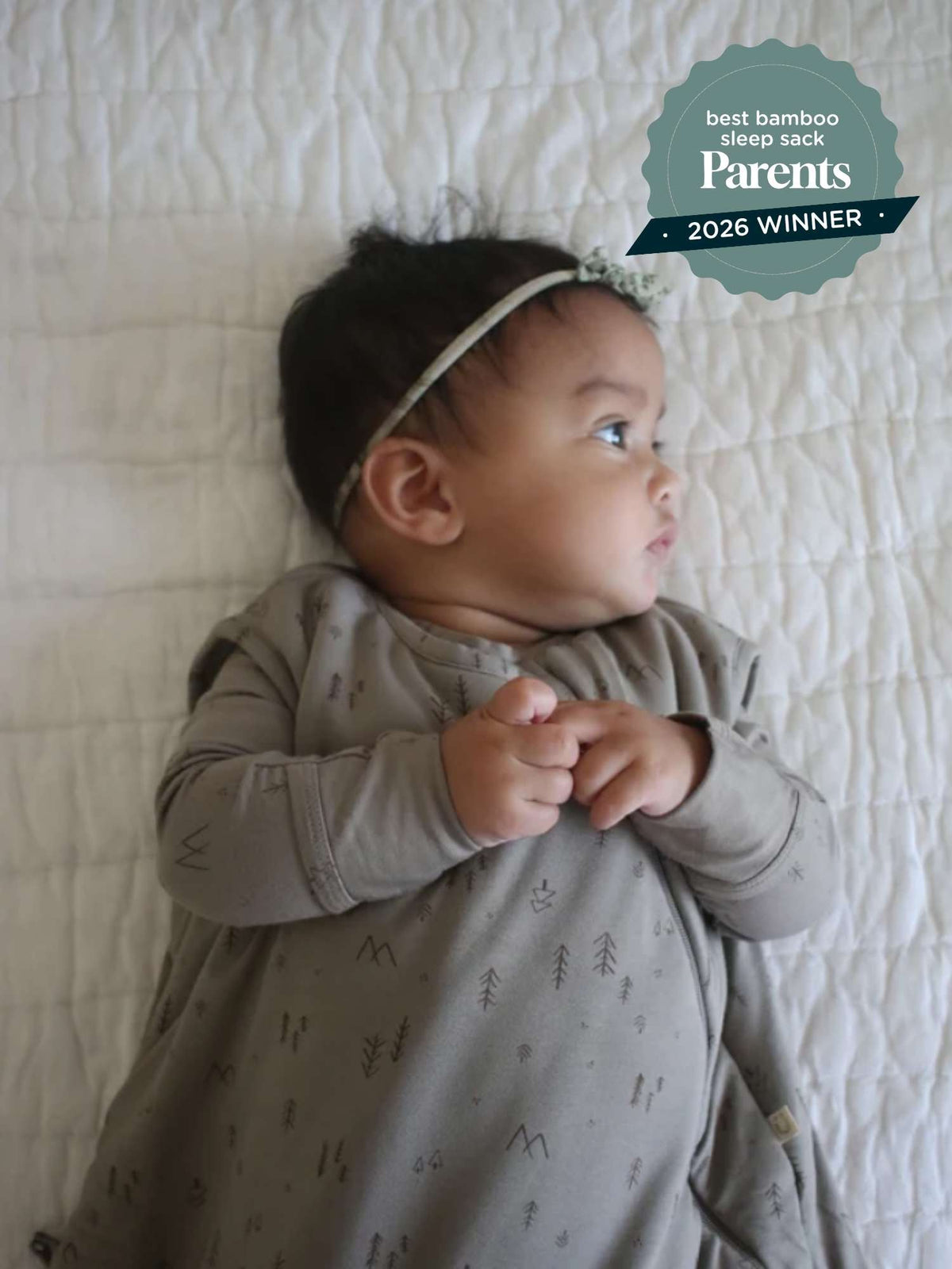 Beige baby sleep sack with tree motif, long sleeves, and front zipper