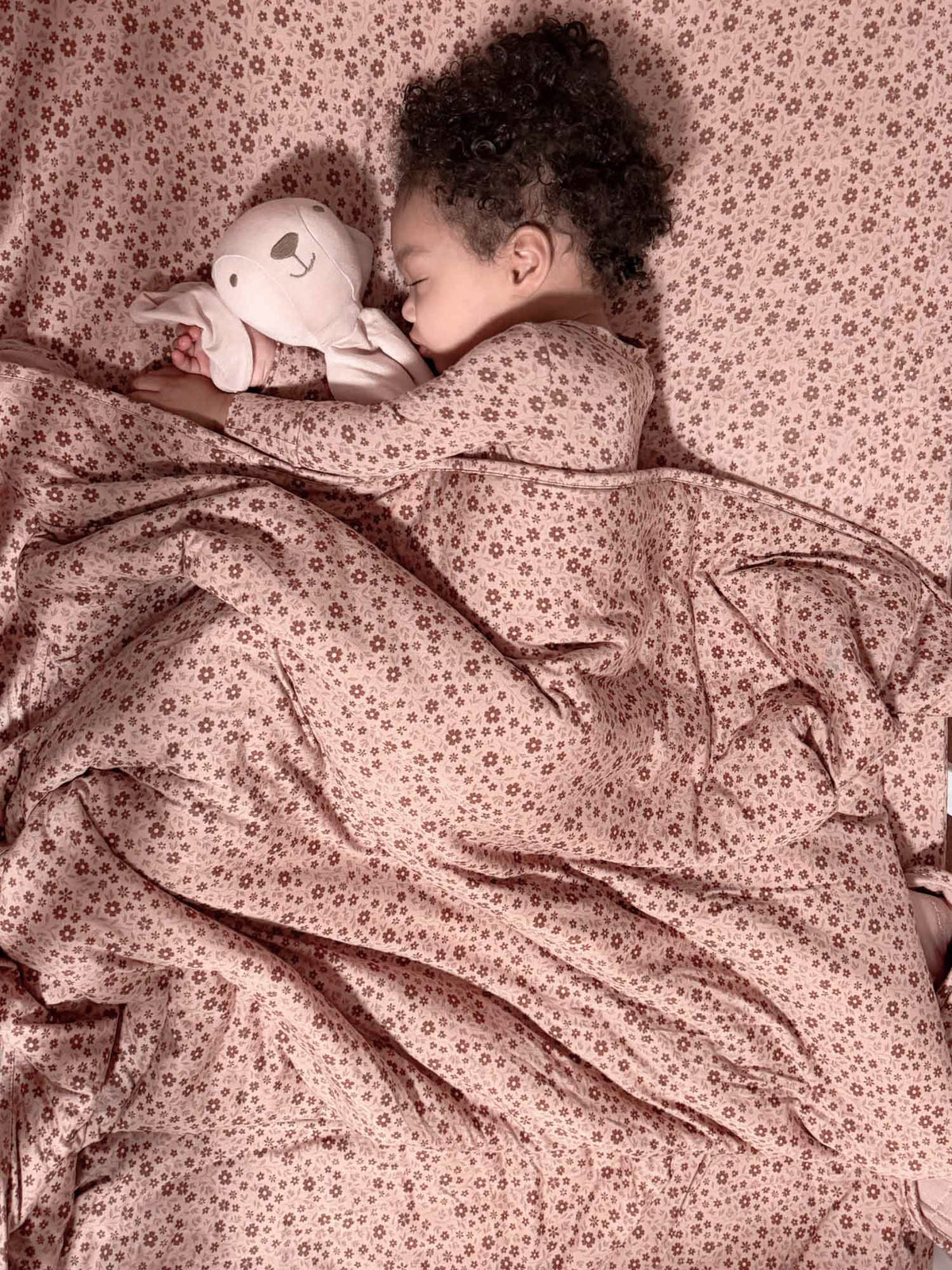 Petal-pattern blanket with soft, layered fabric; child cuddling in floral print