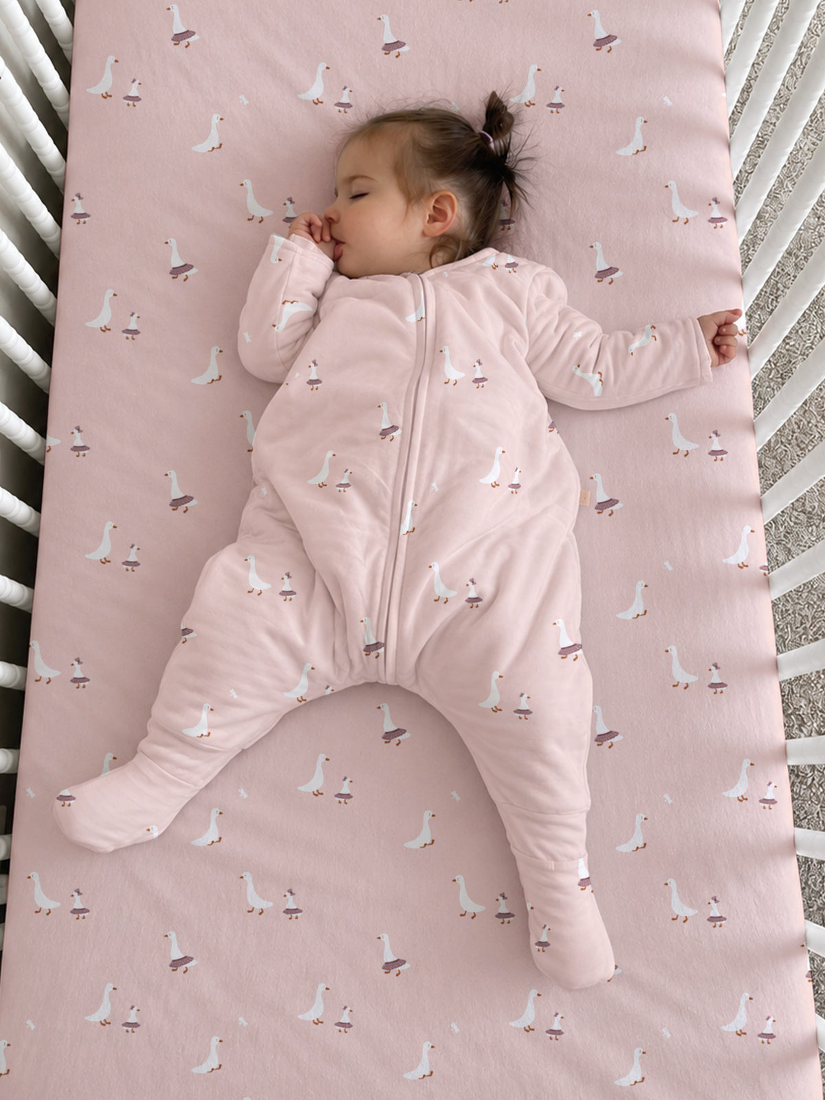 Light pink long-sleeve footie sleep sack with goose print and front zipper